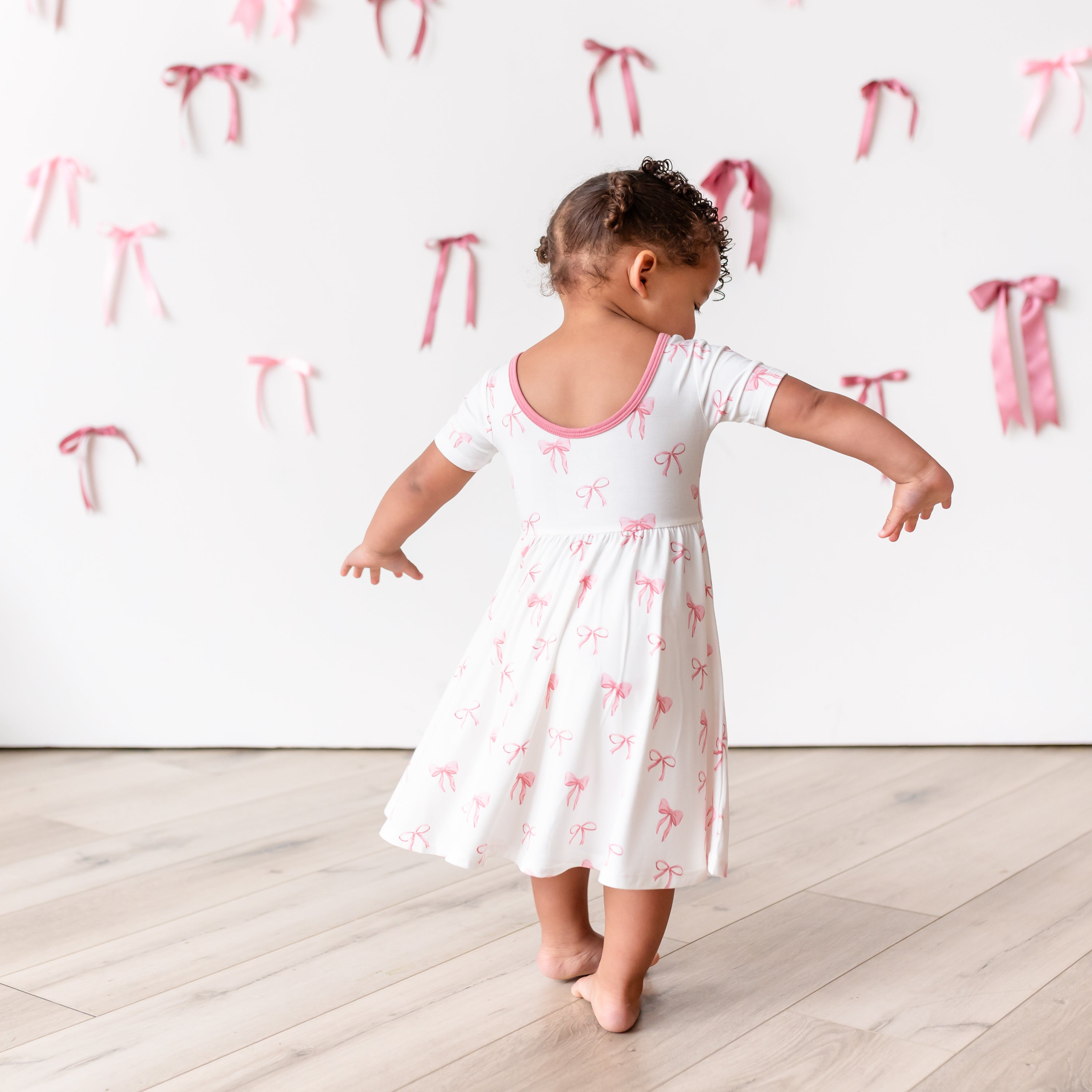 Little girl twirling in Twirl Dress in Bow