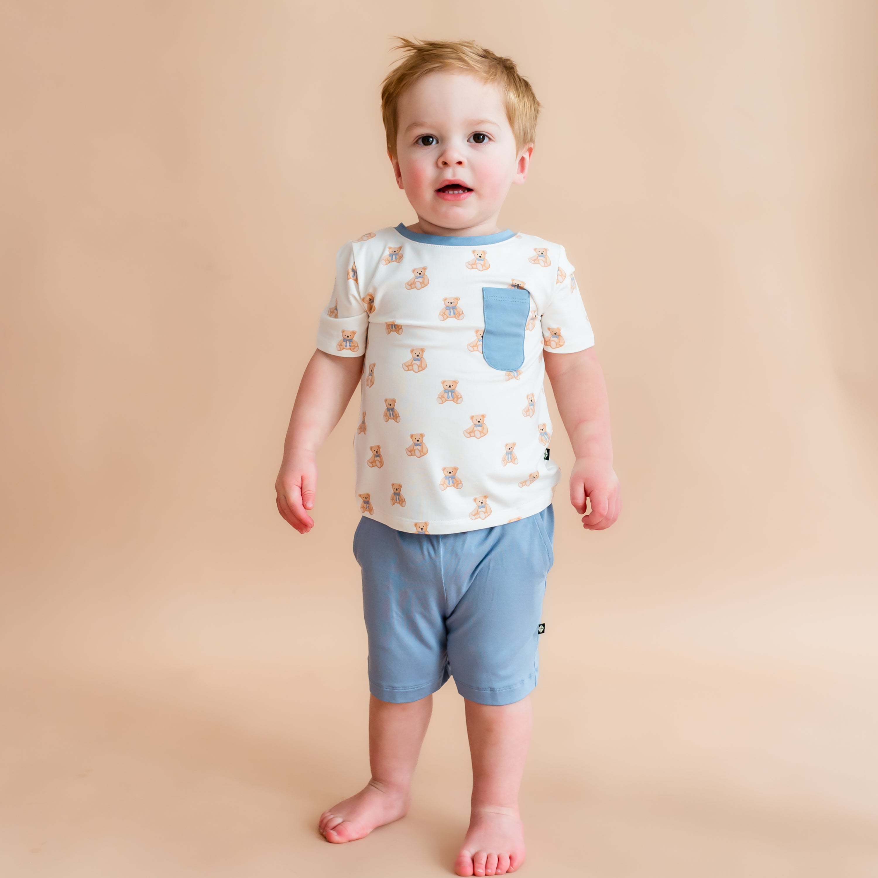 Boy modeling Toddler Crew Neck Tee in Teddy Bear and Slate shorts