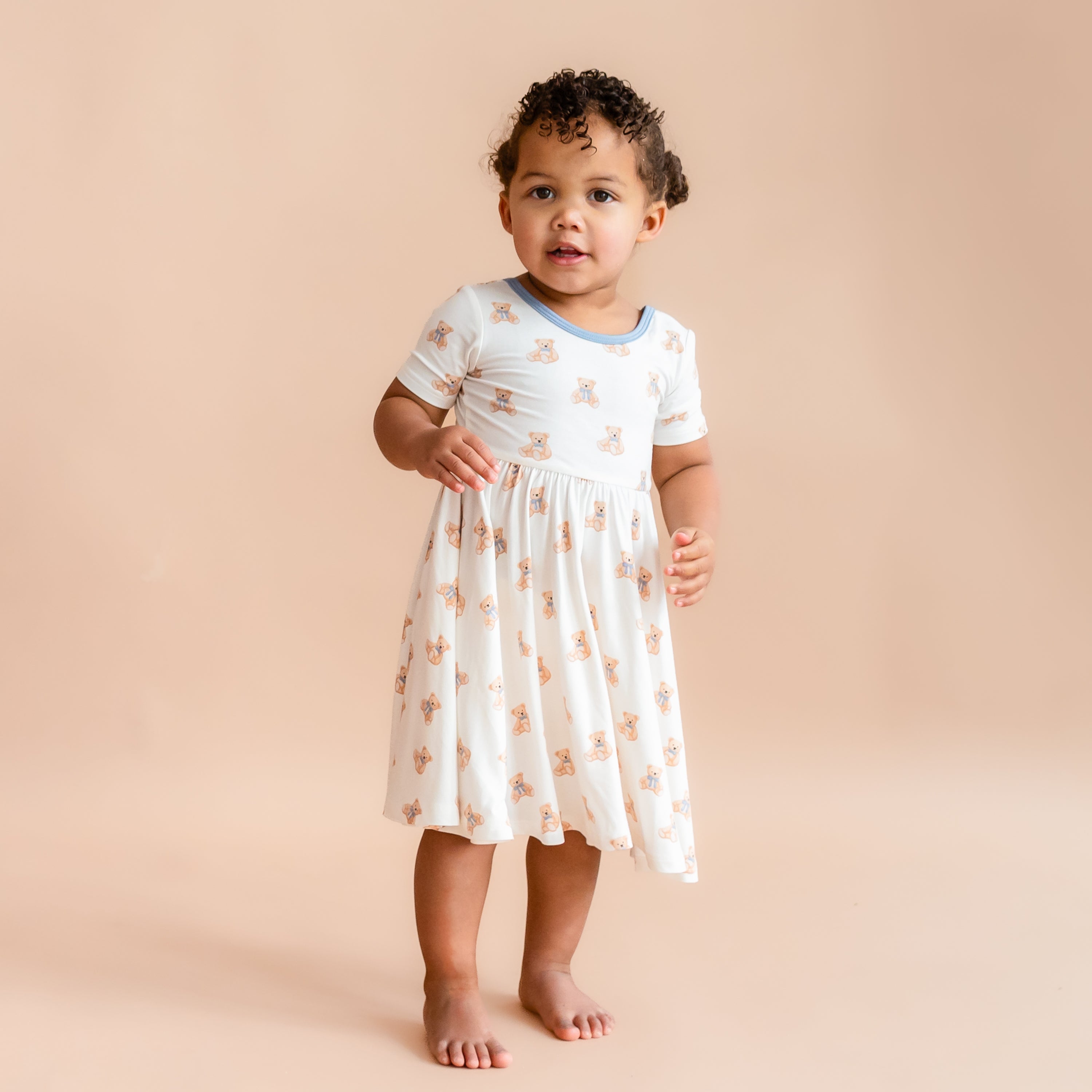 Little girl wearing Twirl Dress in Teddy Bear