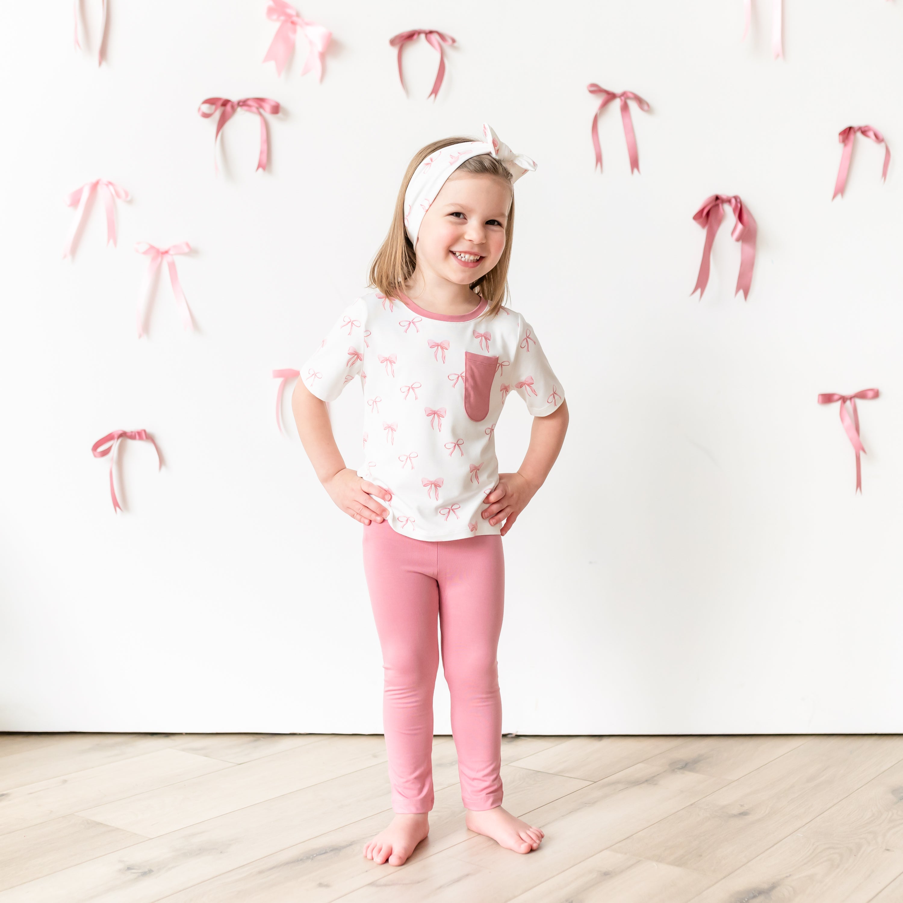 Child modeling Toddler Crew Neck Tee in Bow and apple blossom leggings