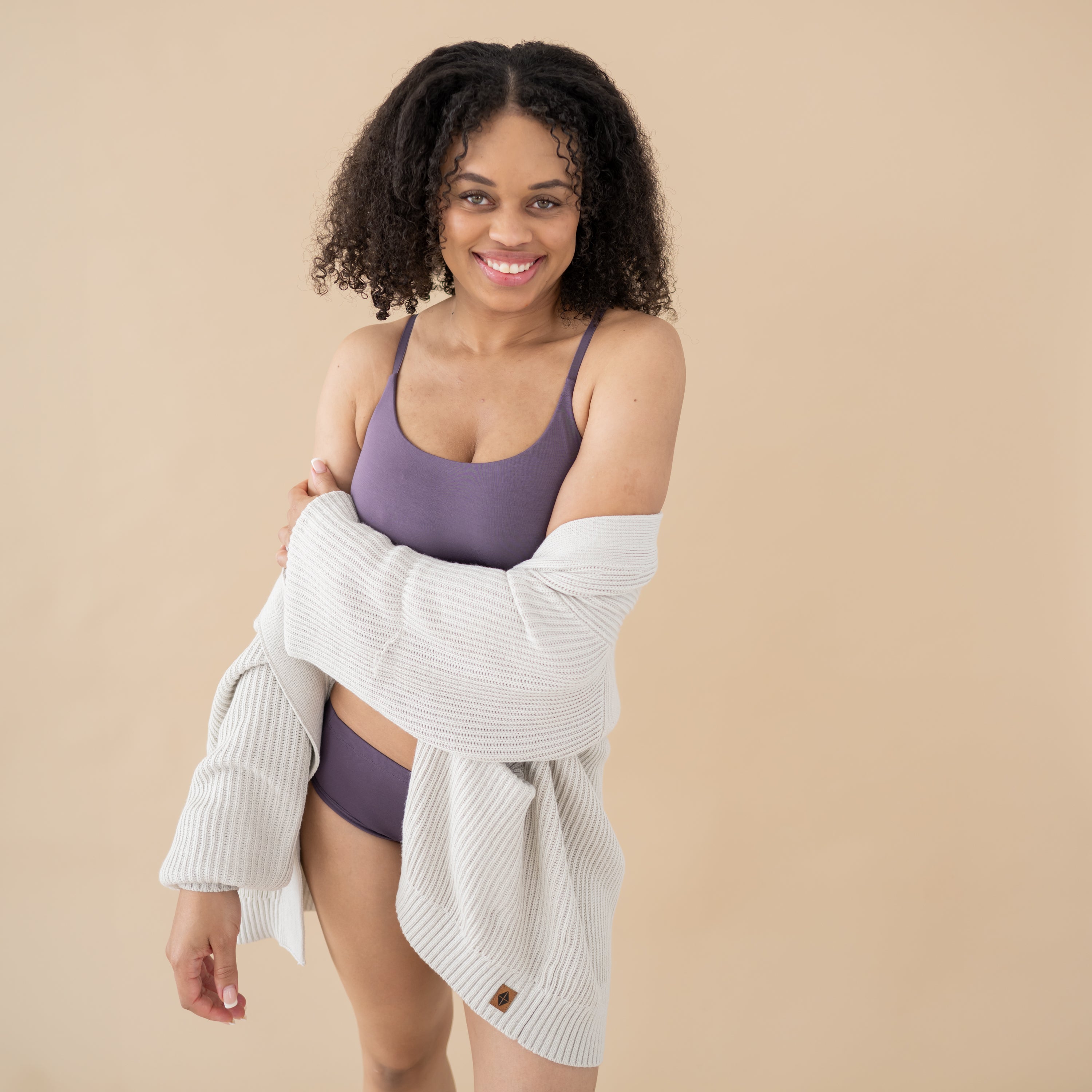 Woman wearing Currant Kyte Intimates wrapped in a cozy Chunky Knit Women's Oversized Cardigan in Oat