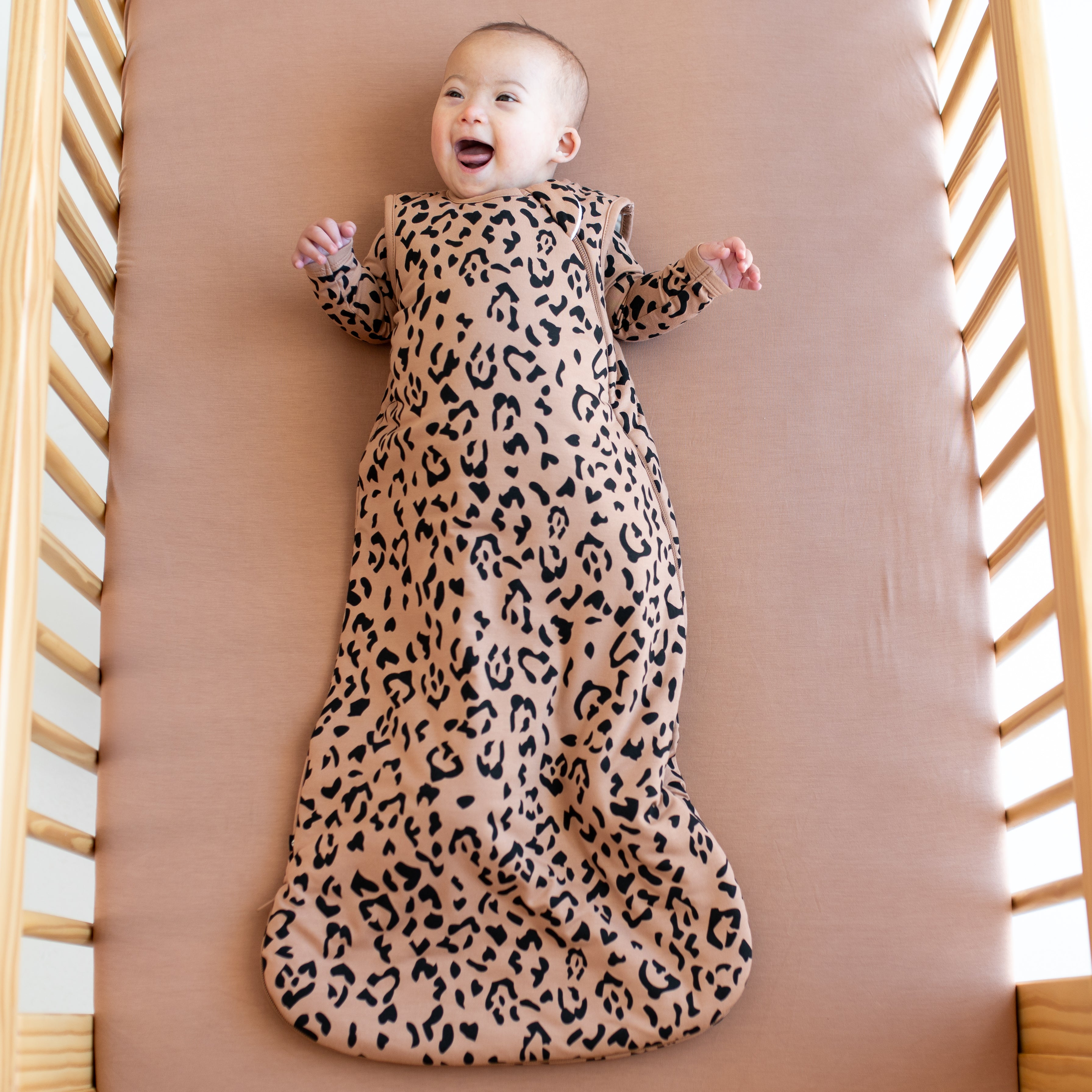 Baby wearing Sleep Bag in Latte Leopard 1.0 TOG and matching pajamas