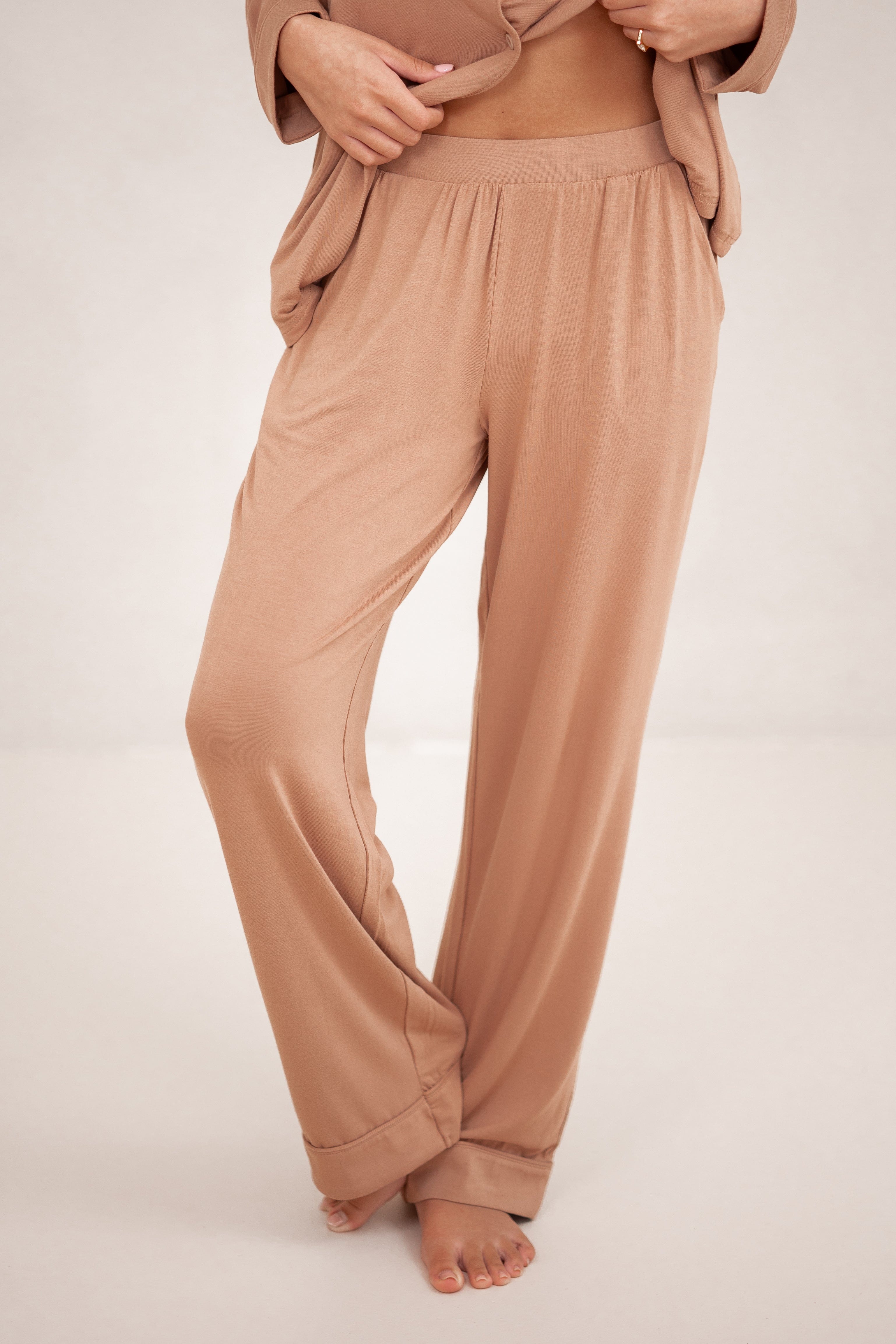 The pants of the Long-Sleeved Women's Pajama Set in Latte with Latte Trim shown on a model