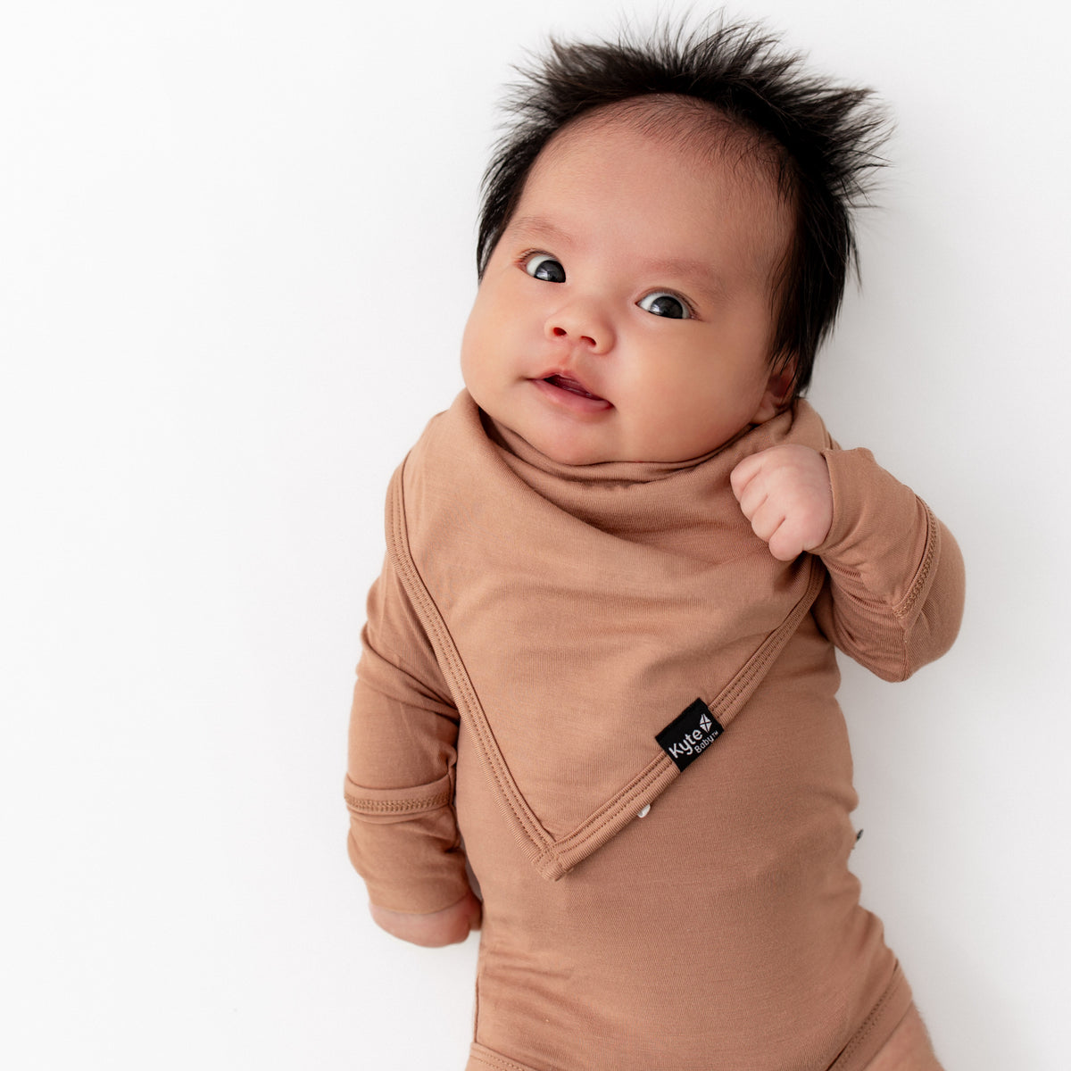 Newborn wearing Bib in Latte with matching long sleeve bodysuit