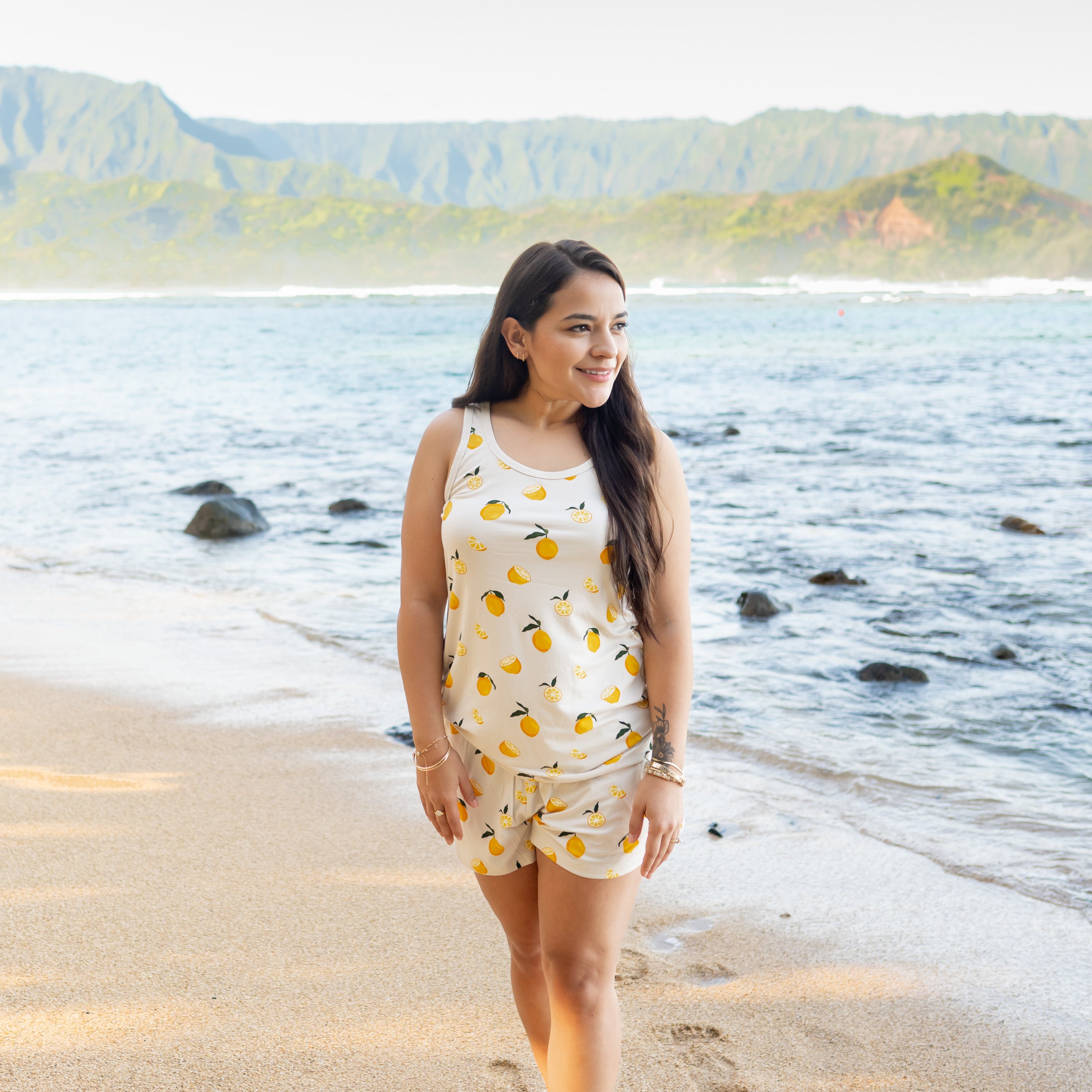 Woman modeling Women’s Tank Set in Lemon on beach