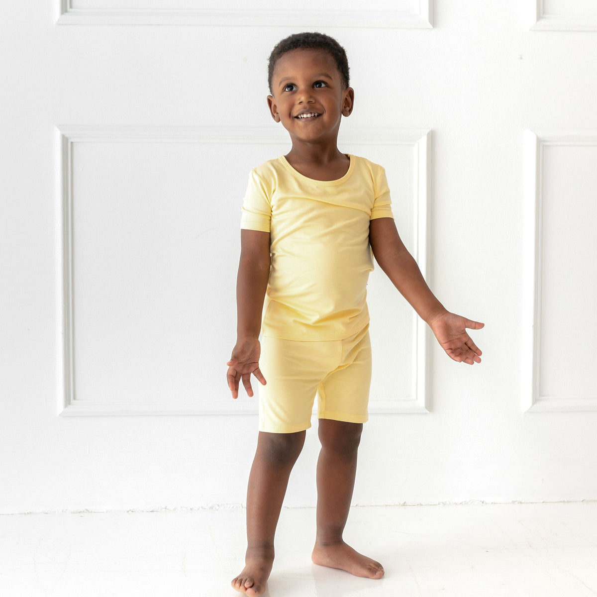 toddler wearing short sleeve pajamas in lilikoi