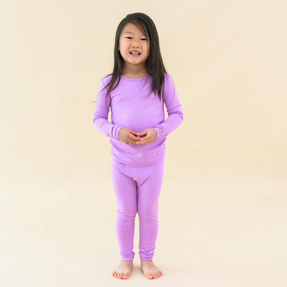 toddler modeling long sleeve pajamas in poi