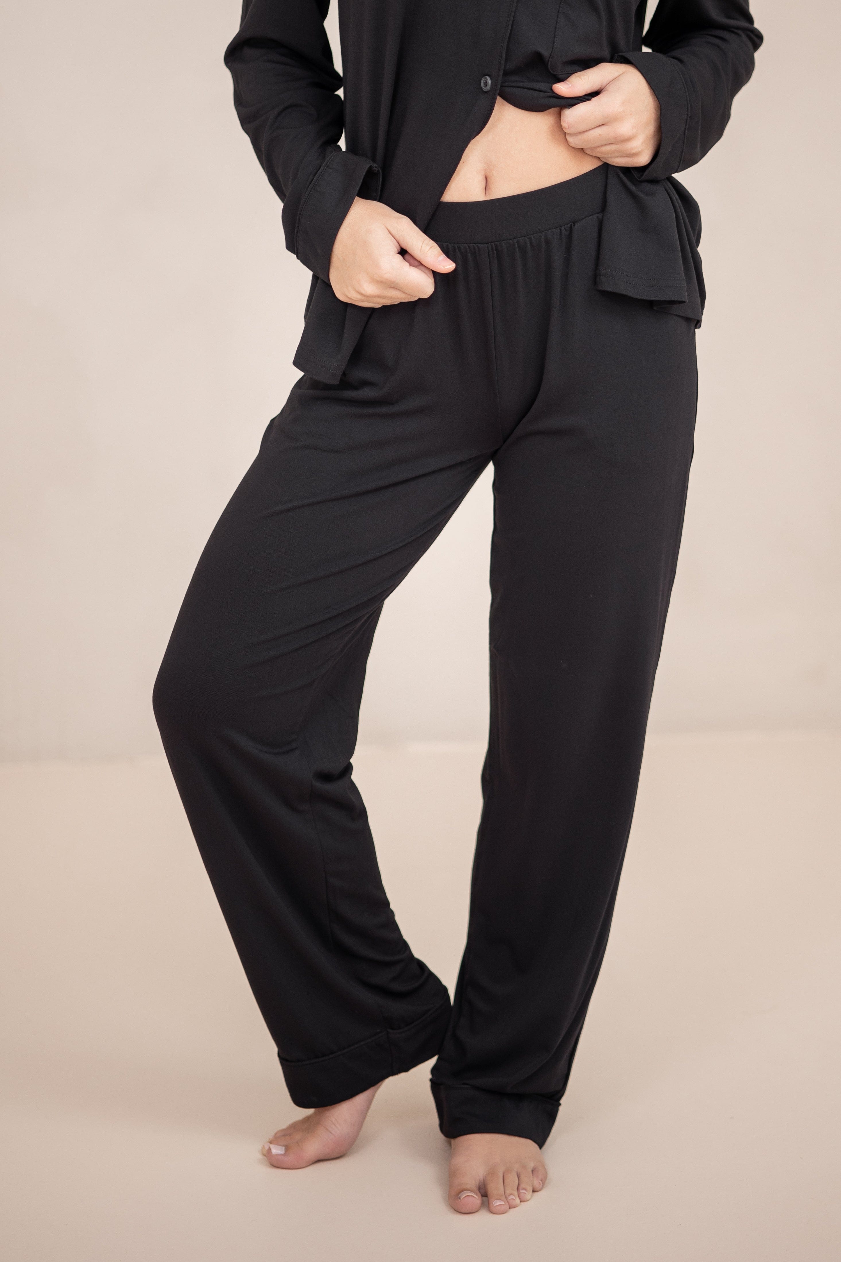 The pants of the Long-Sleeved Women's Pajama Set in Midnight with Midnight Trim shown on a model