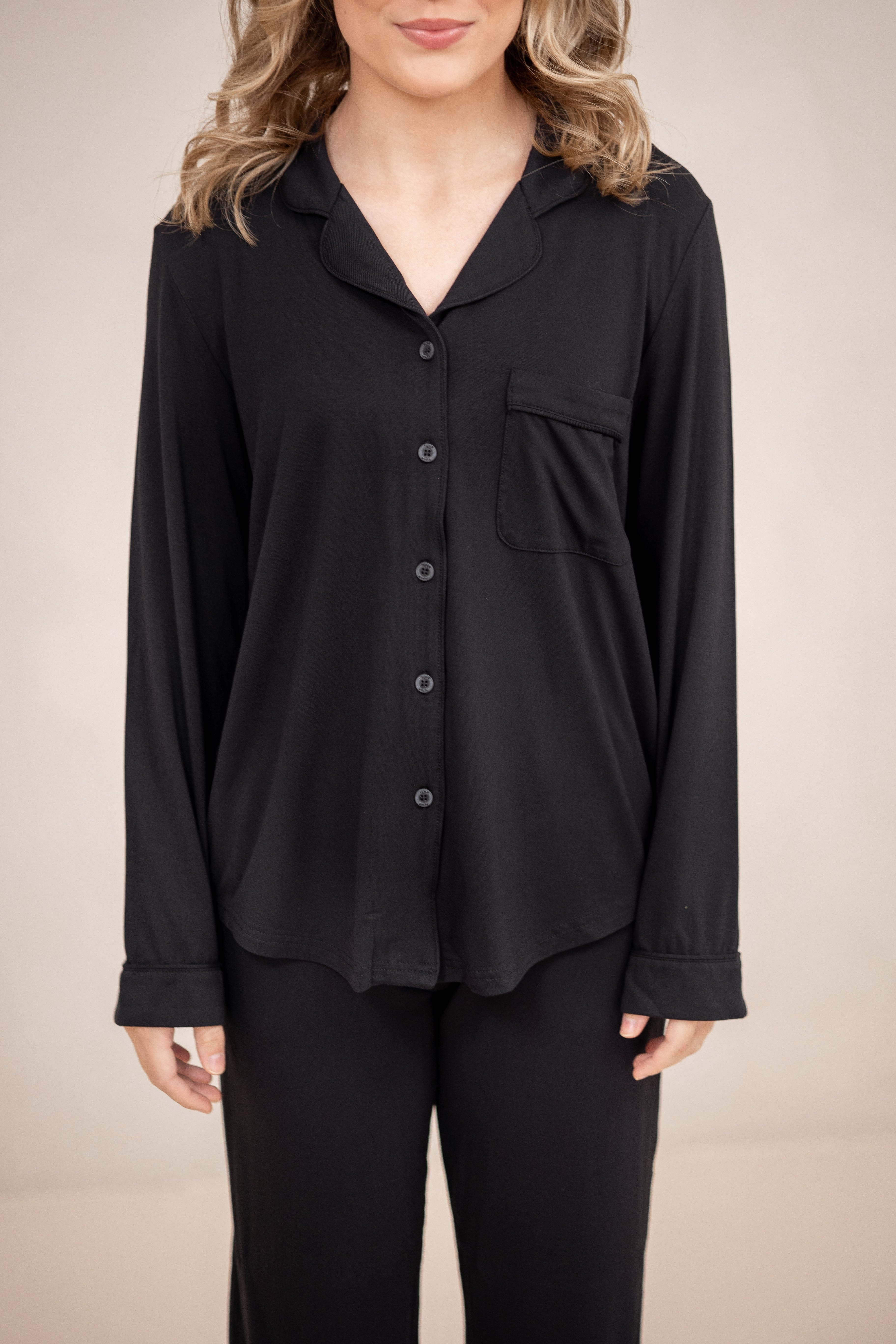 The shirt of the Long-Sleeved Women's Pajama Set in Midnight with Midnight Trim shown on a model