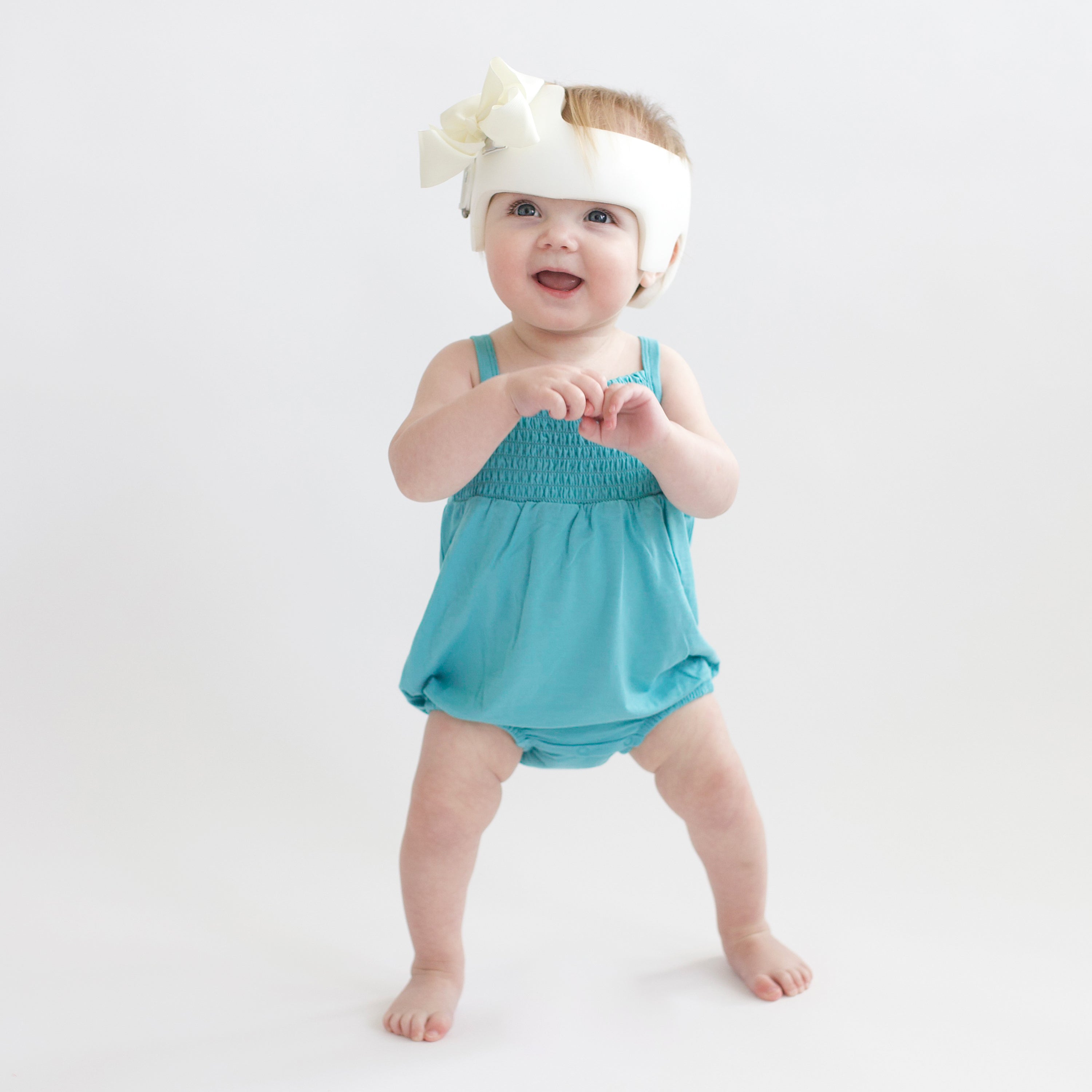 Toddler wearing Smocked Bubble Romper in Makai