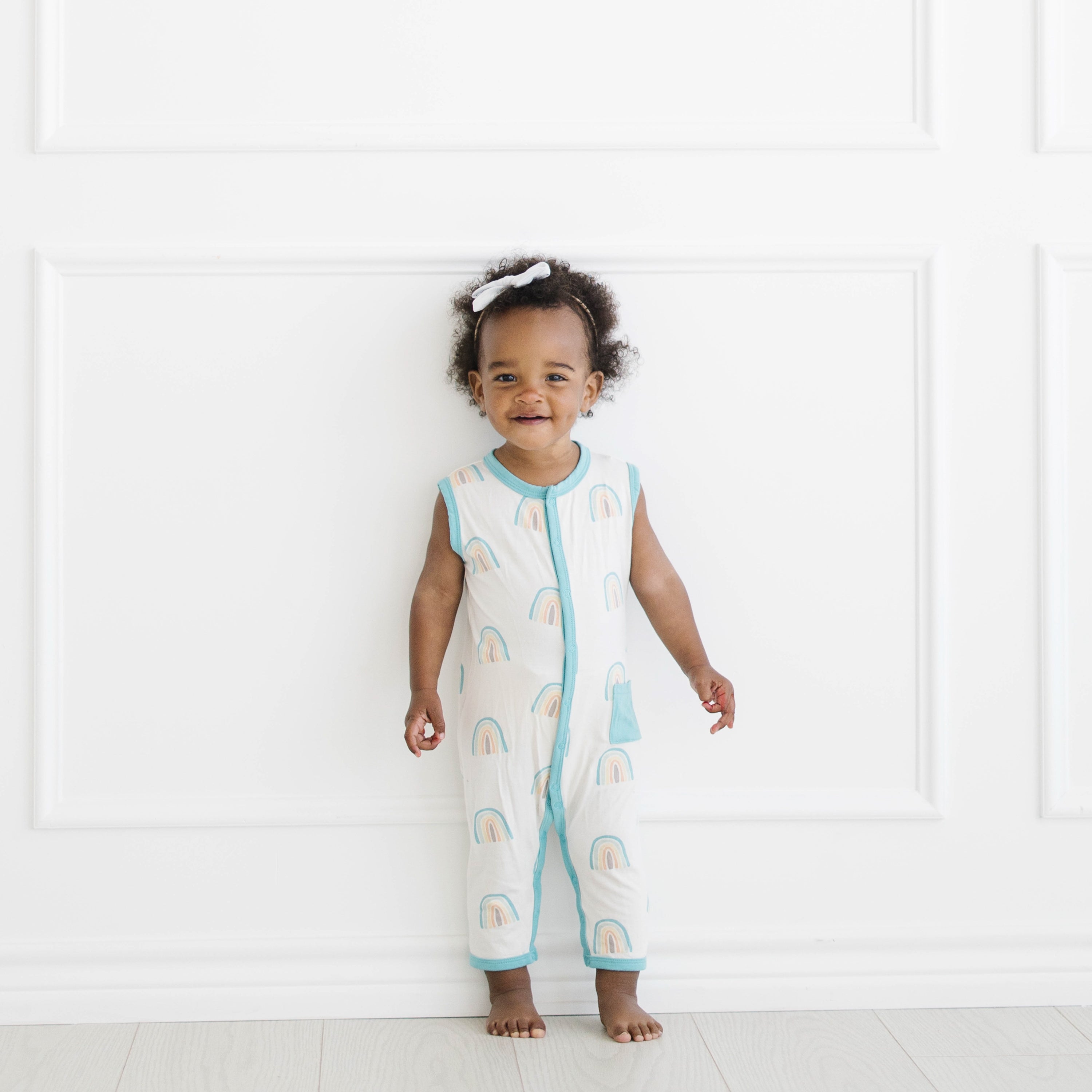 Toddler wearing Sleeveless Romper in Makai Rainbow with Contrast Trim