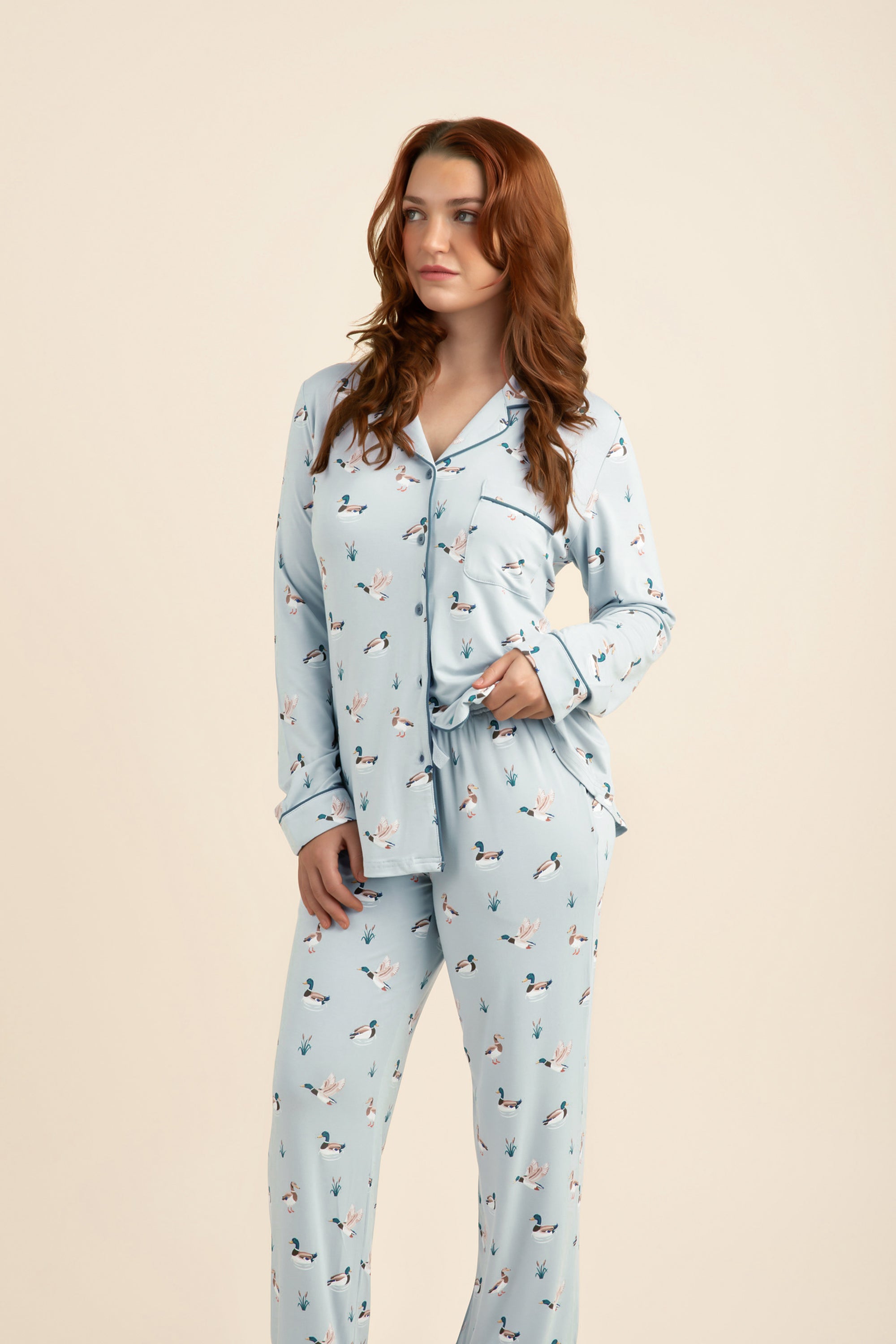 Female modeling the Long-Sleeved Women's Pajama Set in Mallard Duck in front of a light taupe background