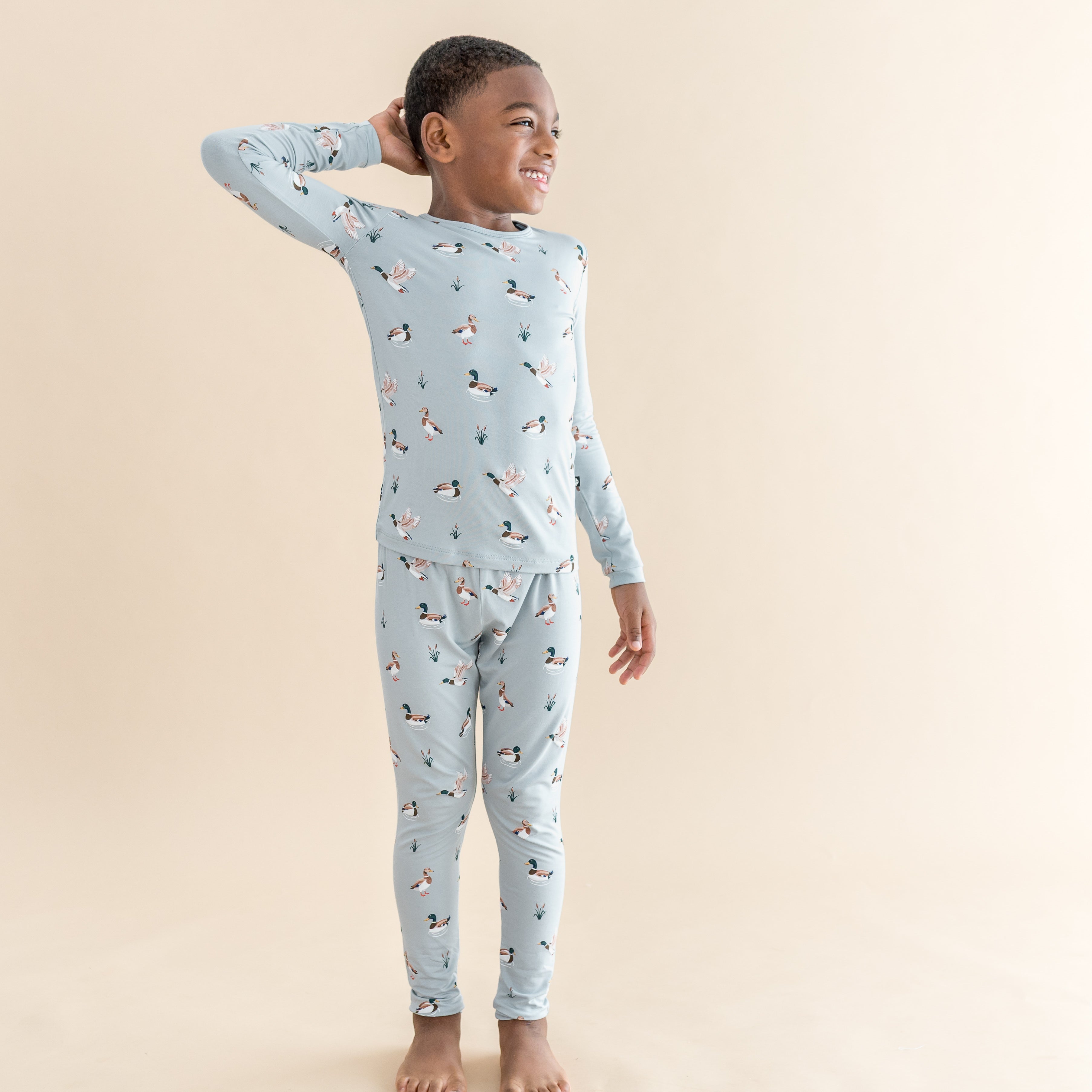 Young boy posing wearing the Long Sleeve Pajamas in Mallard Duck