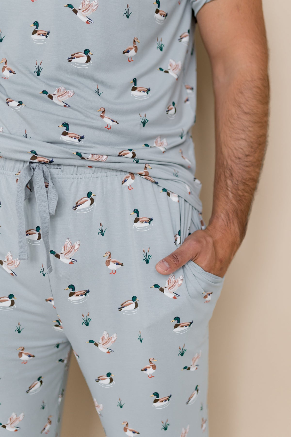 Close up of the drawstring waist and pocket on the Men's Lounge Pants in Mallard Duck shown on a male model