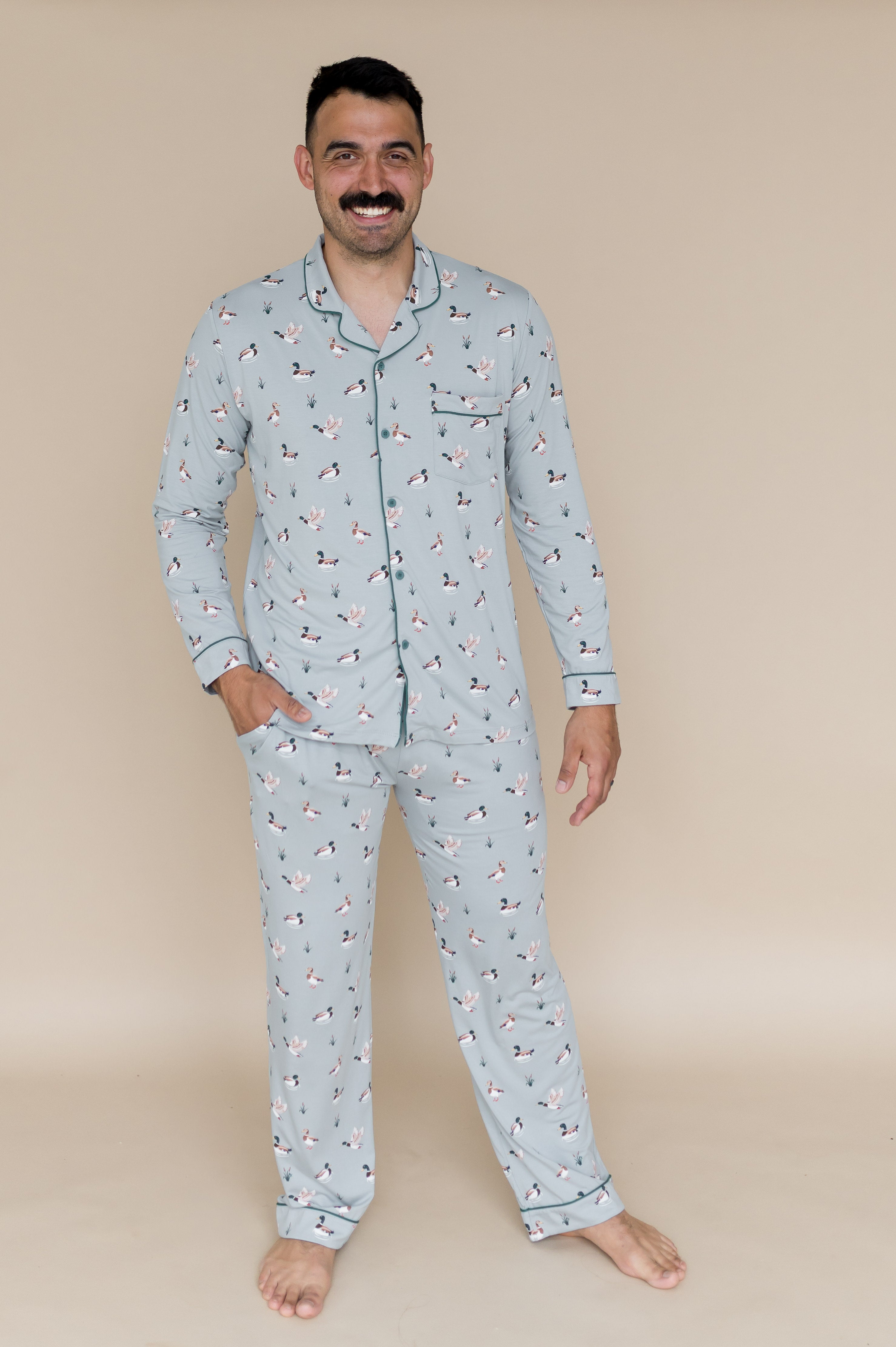 Male modeling the Men's Long Sleeve Pajama Set in Mallard Duck with one hand in the pants pocket