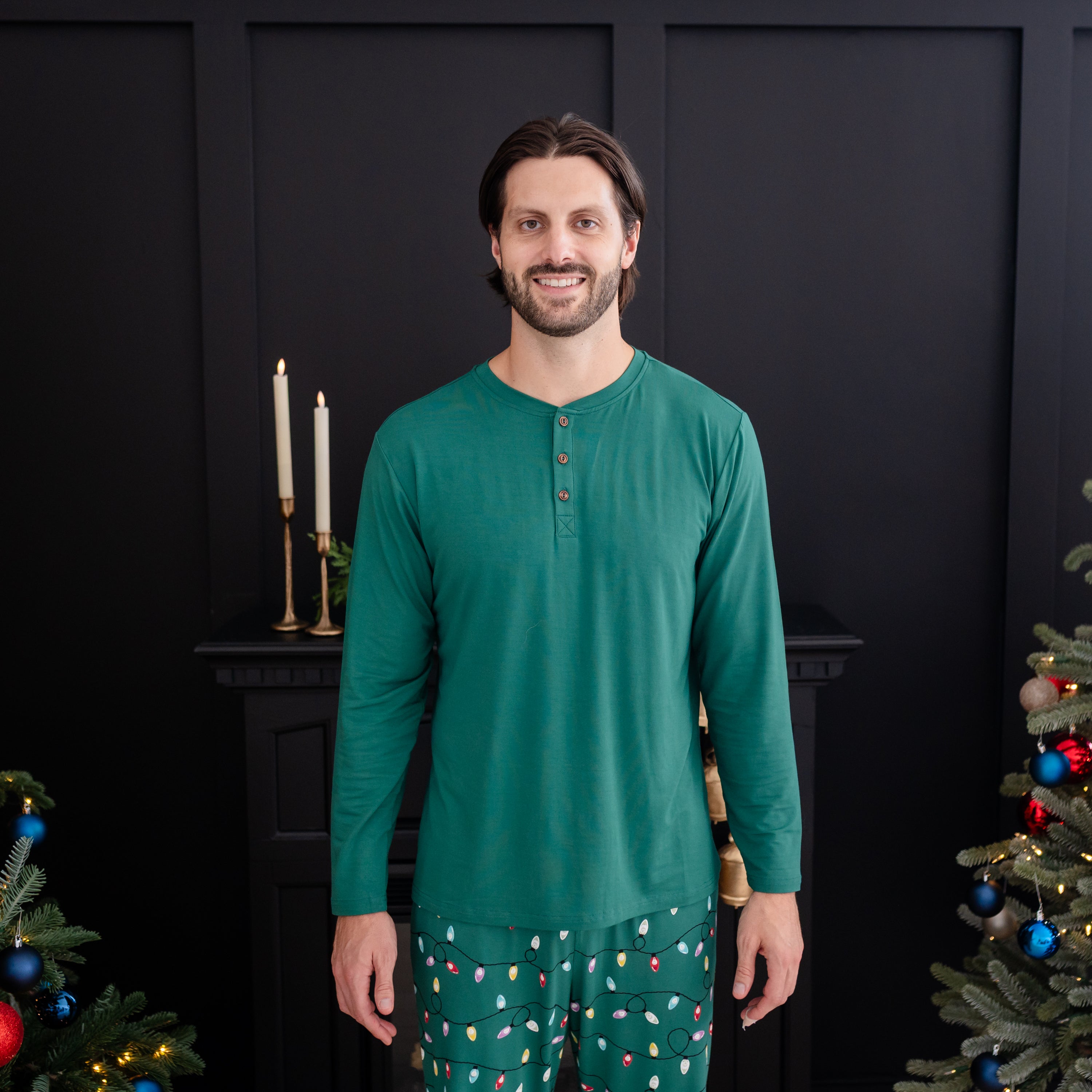 Male model standing wearing the Men's Long Sleeve Henley Top in Emerald