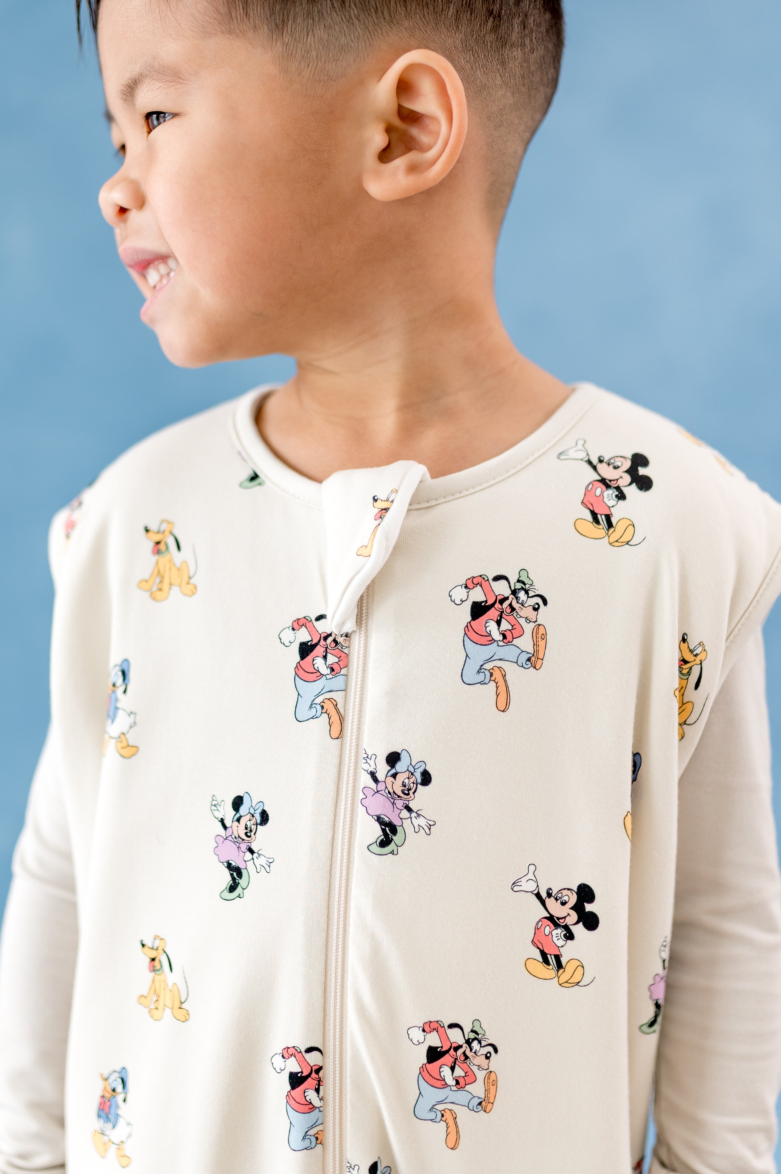 Close up of sleep bag walker in a mickey and friends pattern with zipper garage