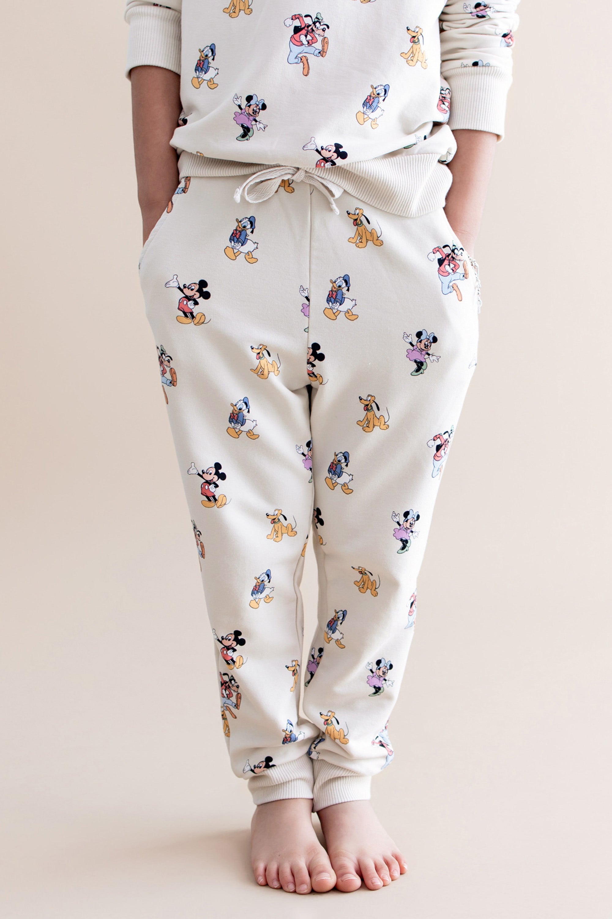 Cream colored jogger pant with mickey and friends pattern