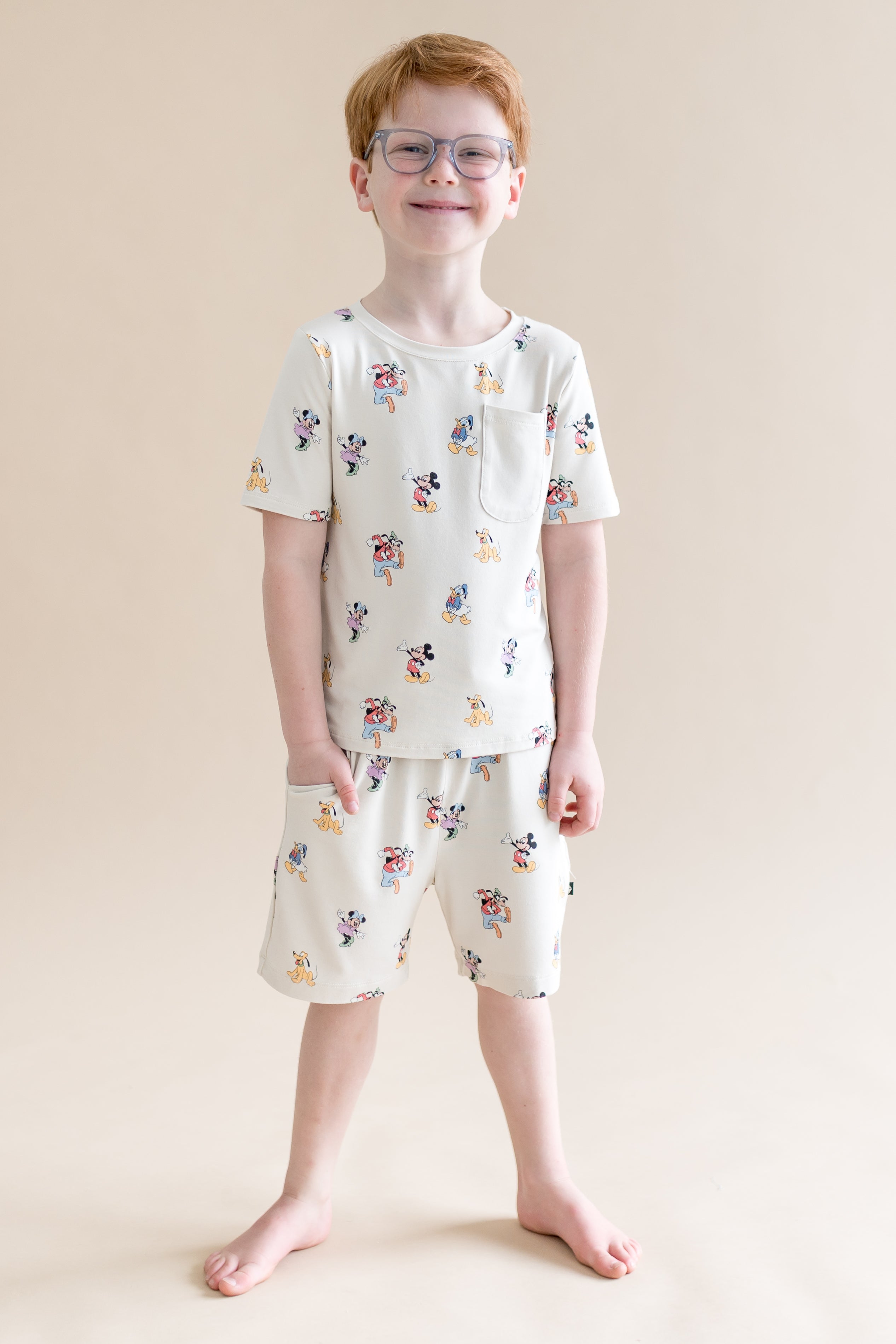 Child wearing Mickey Mouse and Friends printed drawstring shorts with pocket and matching tshirt