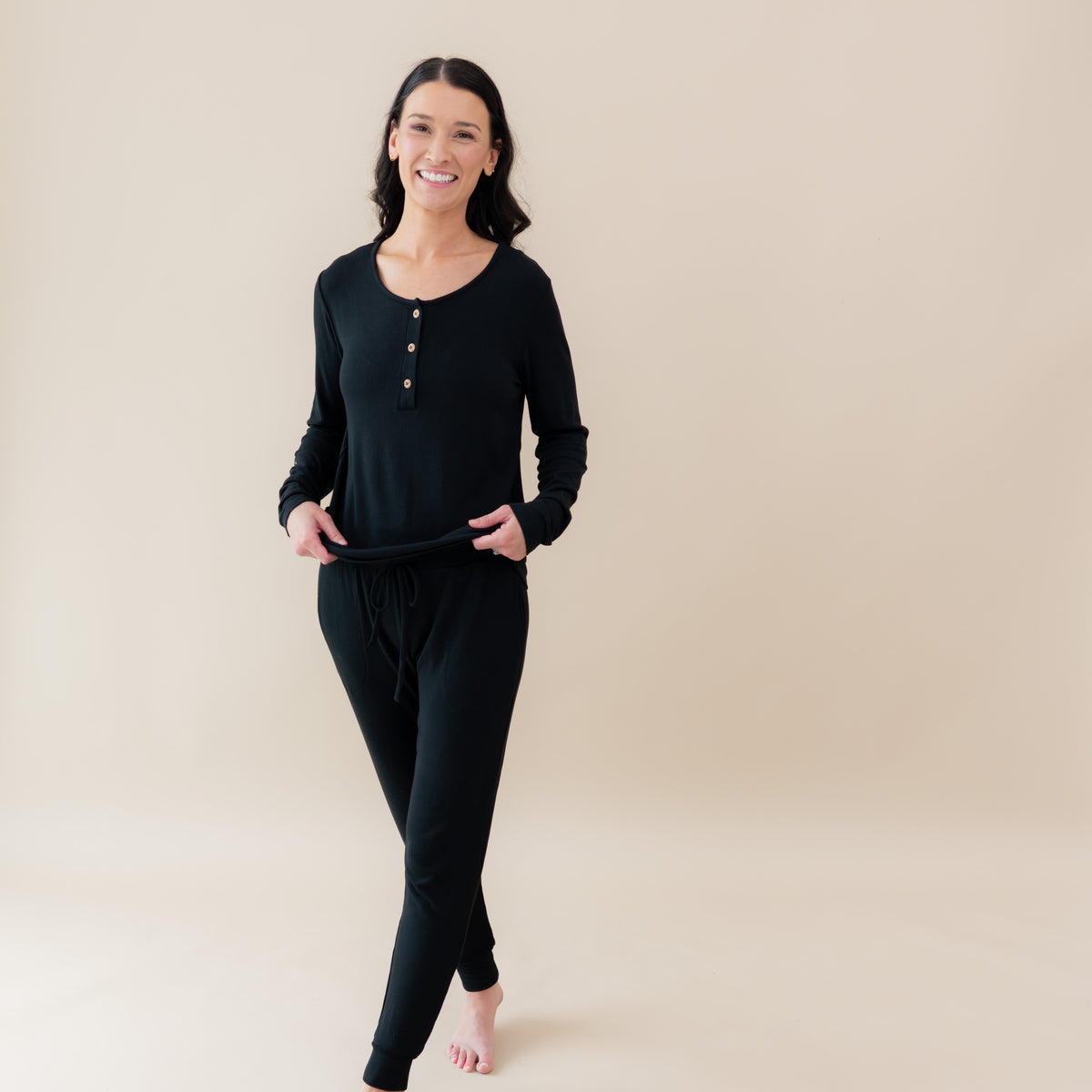 Woman modeling Women's Ribbed Henley Top in Midnight and ribbed jogger pants