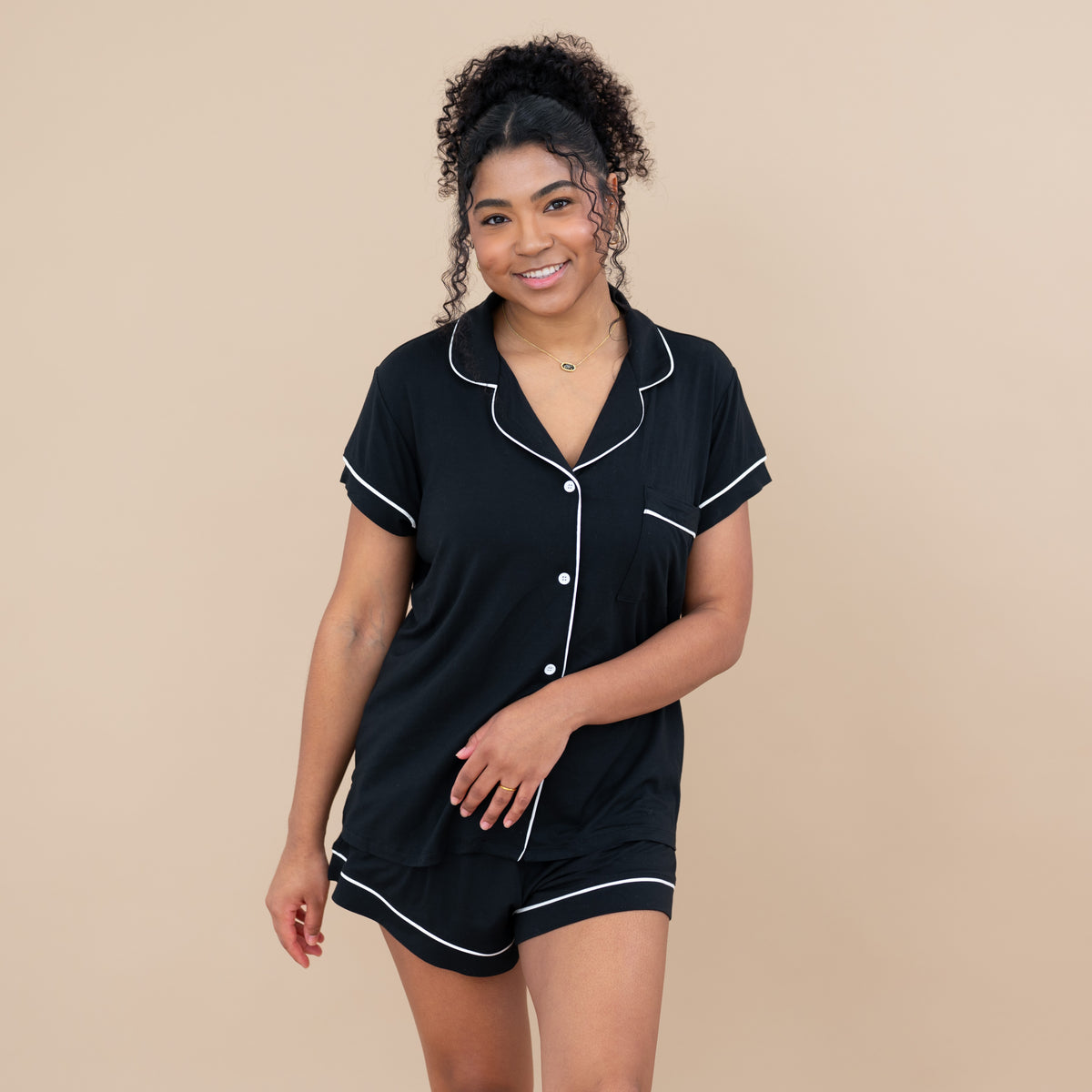 Woman wearing Women’s Short Sleeve Pajama Set in Midnight with Cloud Trim
