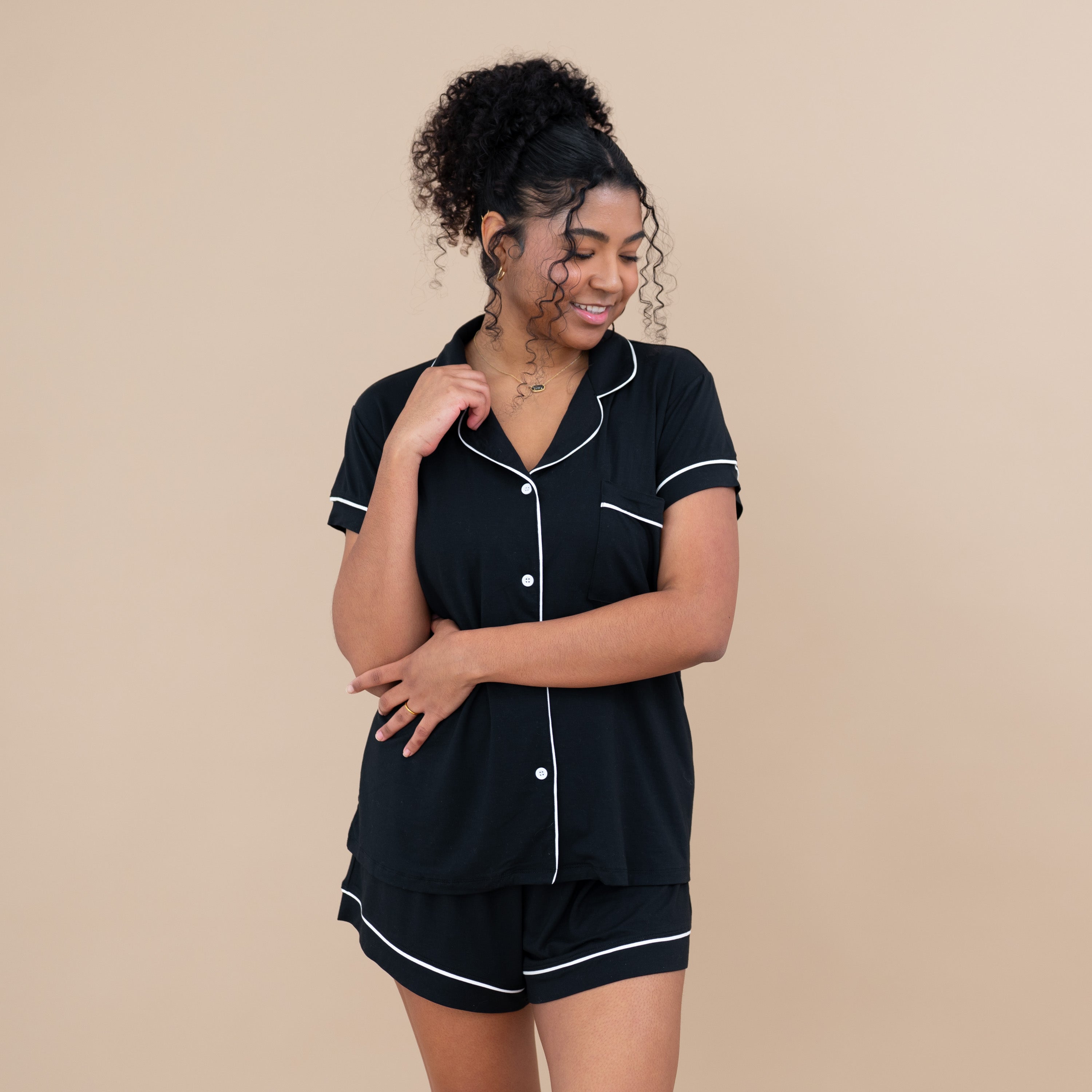 Woman wearing Women’s Short Sleeve Pajama Set in Midnight with Cloud Trim