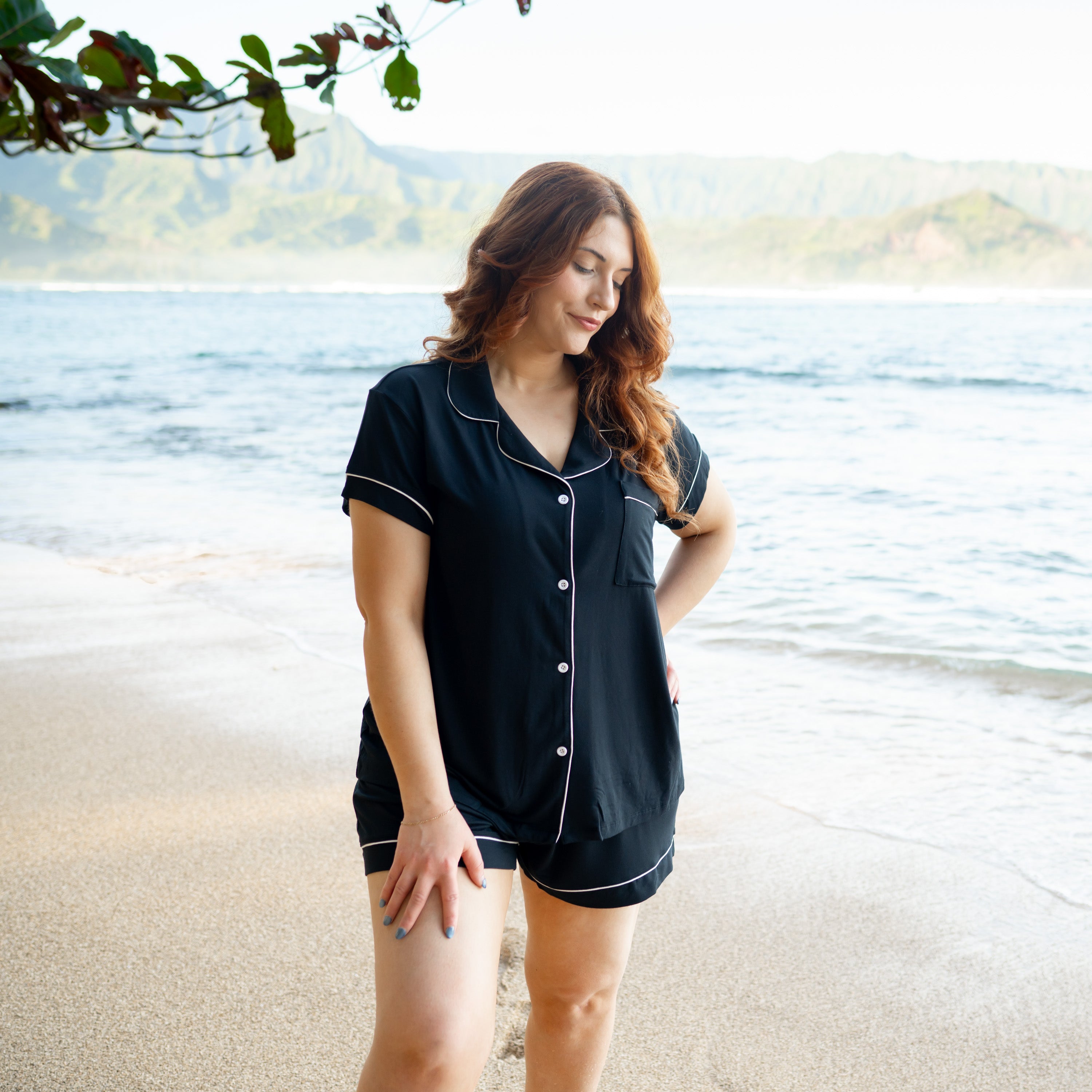 Woman wearing Women’s Short Sleeve Pajama Set in Midnight with Cloud Trim on beach
