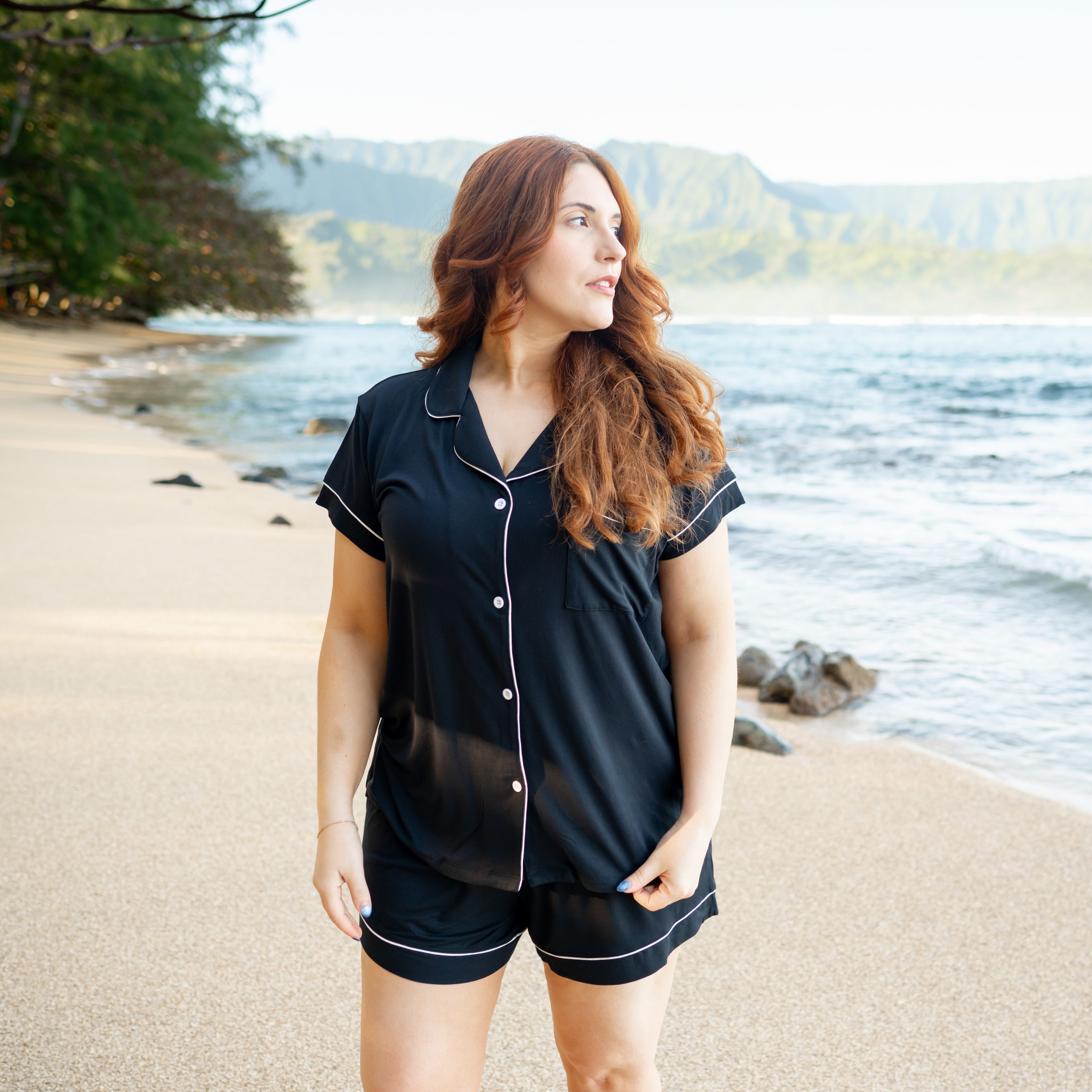 Woman wearing Women’s Short Sleeve Pajama Set in Midnight with Cloud Trim on beach