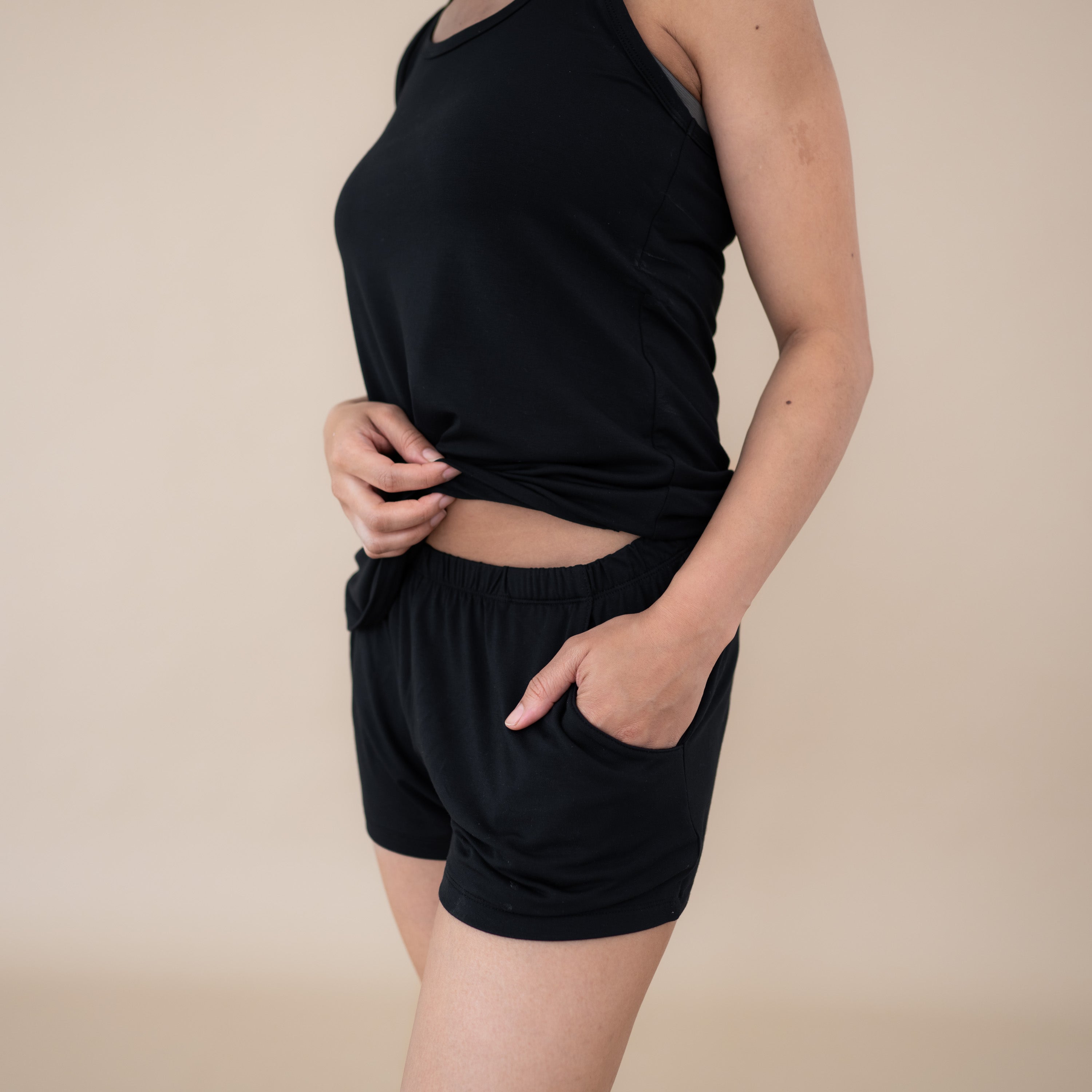 Woman wearing Women’s Tank Set in Midnight showing waist band and pocket