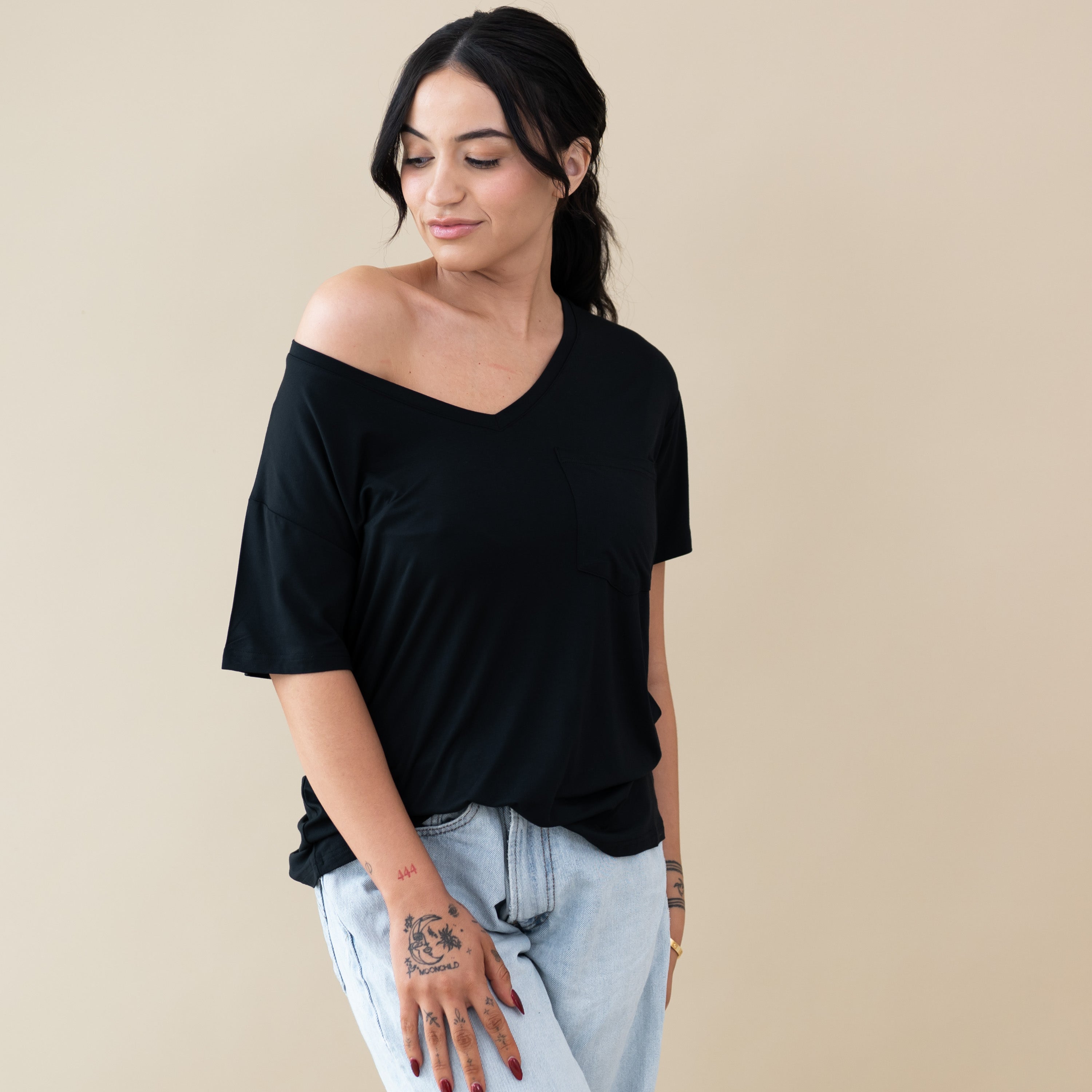 Woman modeling Women’s Relaxed Fit V-Neck in Midnight showing it off-shoulder