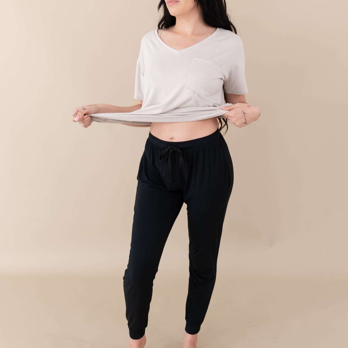 Woman modeling Women's Jogger Pants in Midnight with an oat v-neck