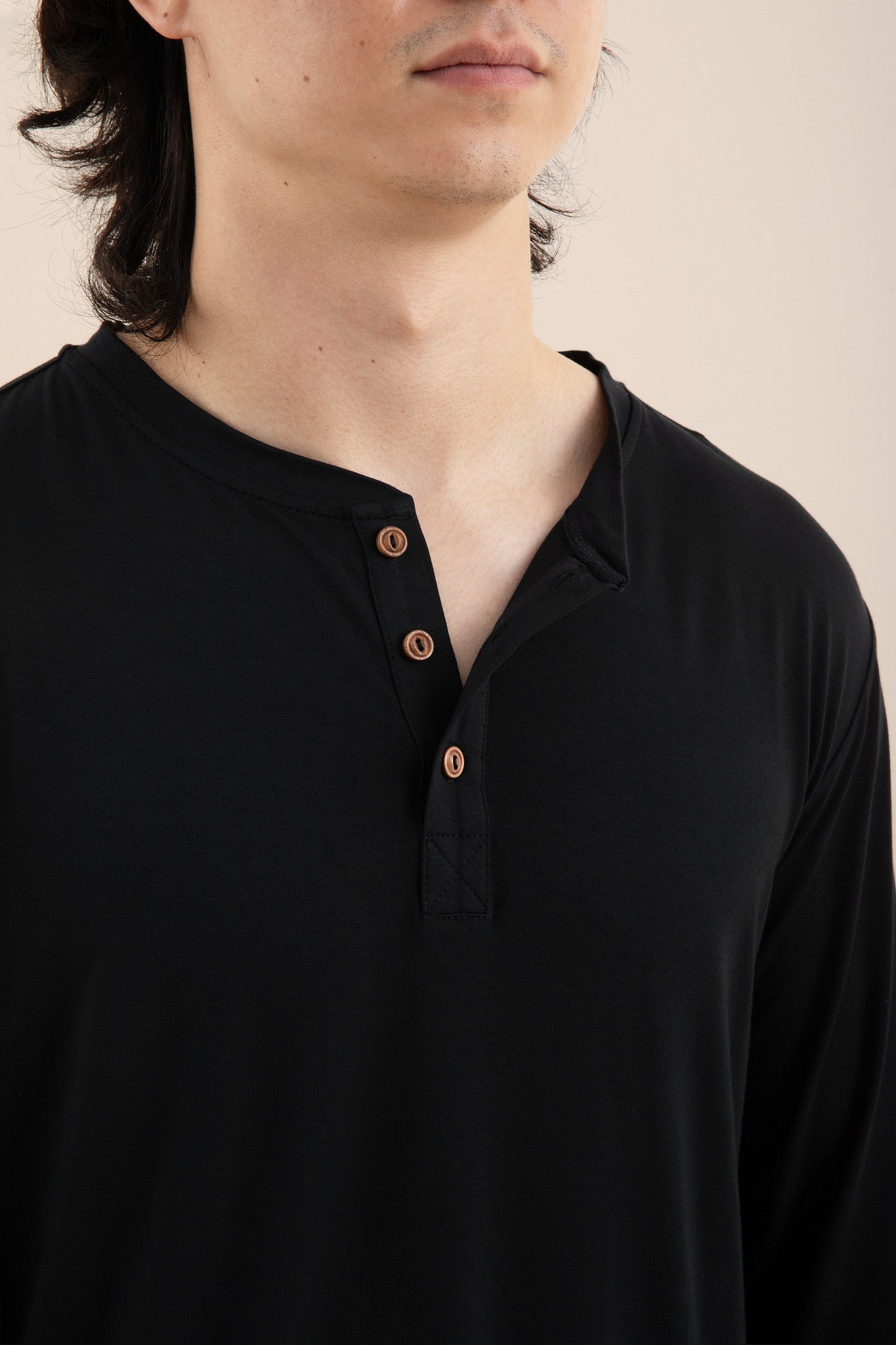 The Men's Long Sleeve Henley Top in Midnight unbuttoned shown on a male model