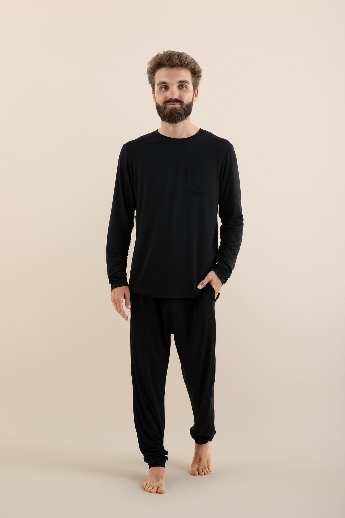 Male model walking wearing the Men's Jogger Set in Midnight in front of a light neutral background