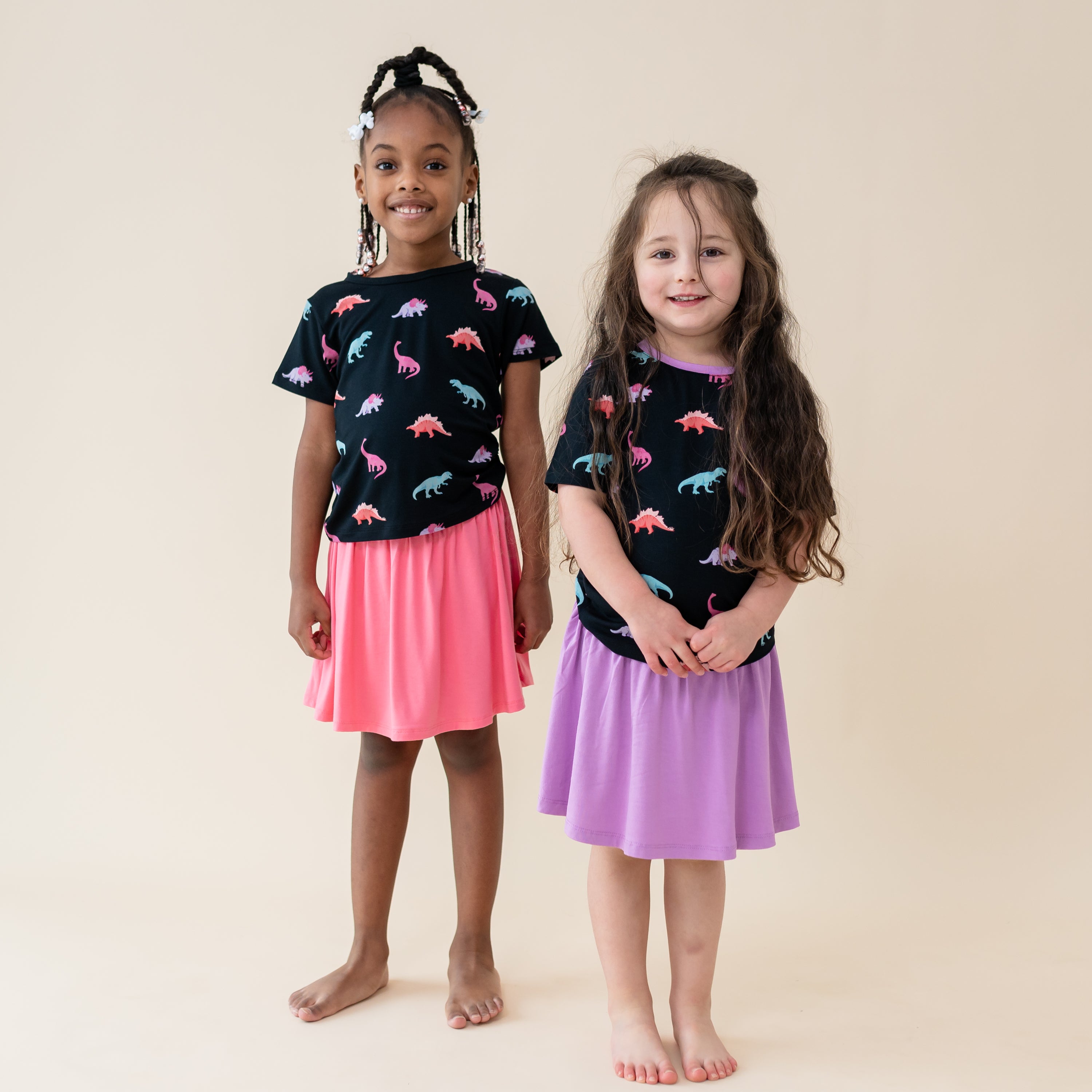 Two girls modeling the Midnight Roar Tees with Poi and Guava Skorts