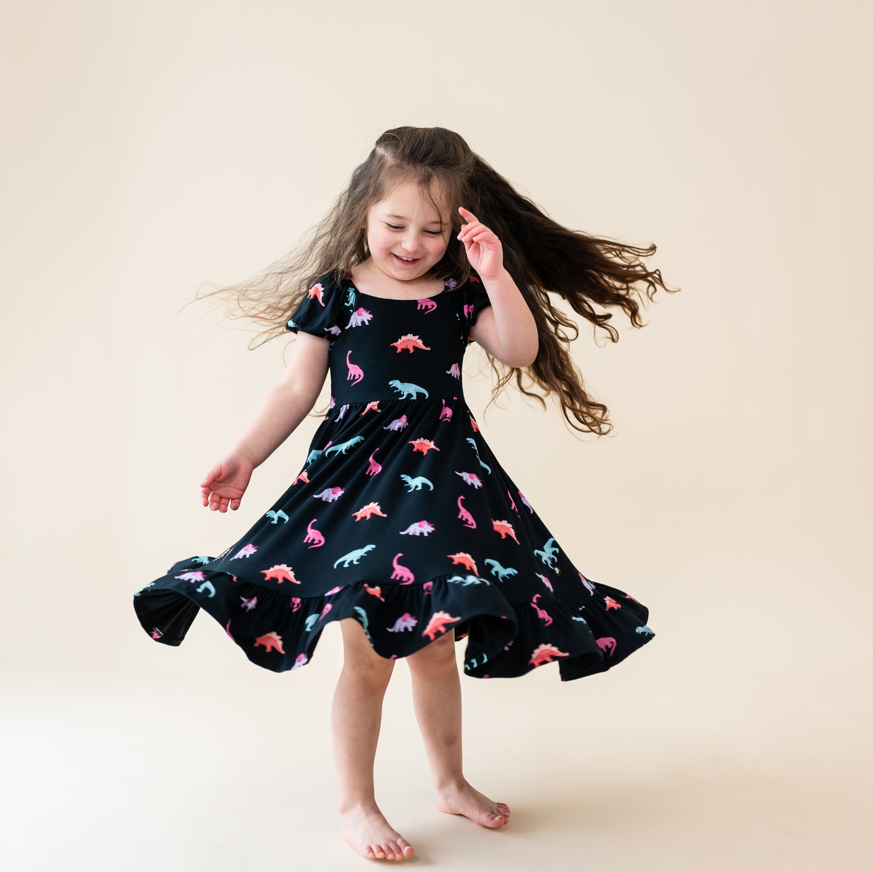 Young girl twirling in the Midnight Roar Puff Sleeve Twirl Dress