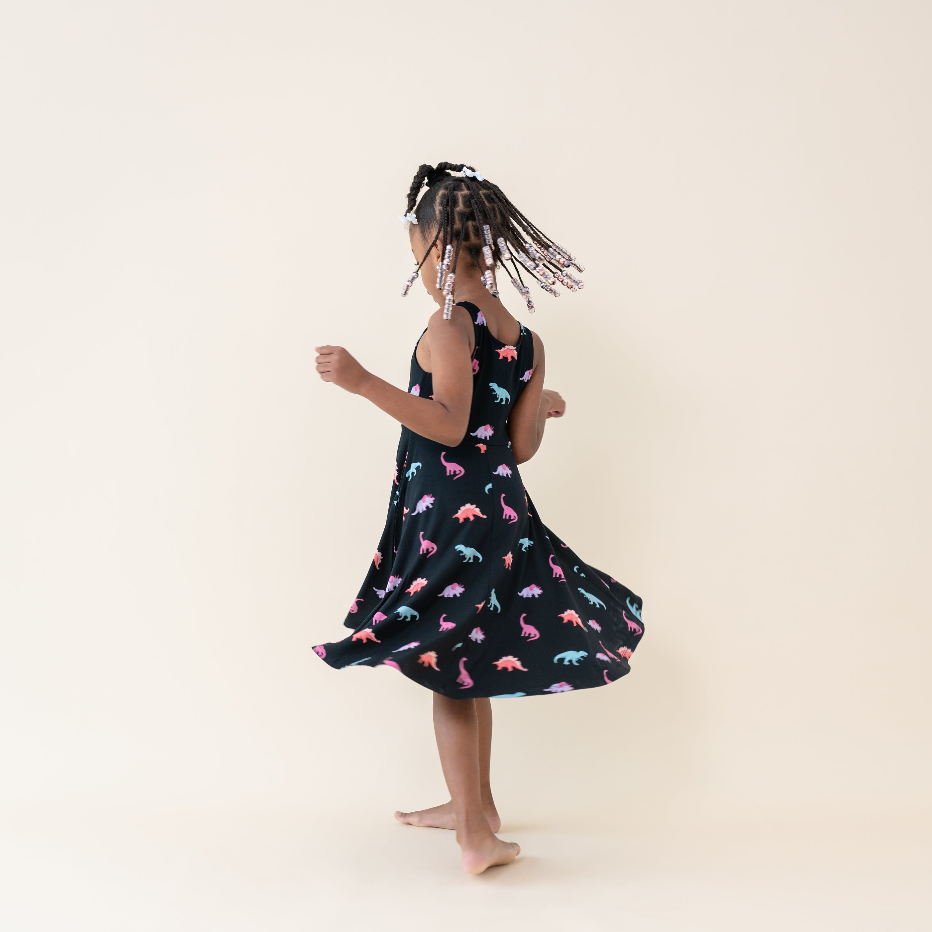 Young girl twirling in the Midnight Roar Tank Twirl Dress