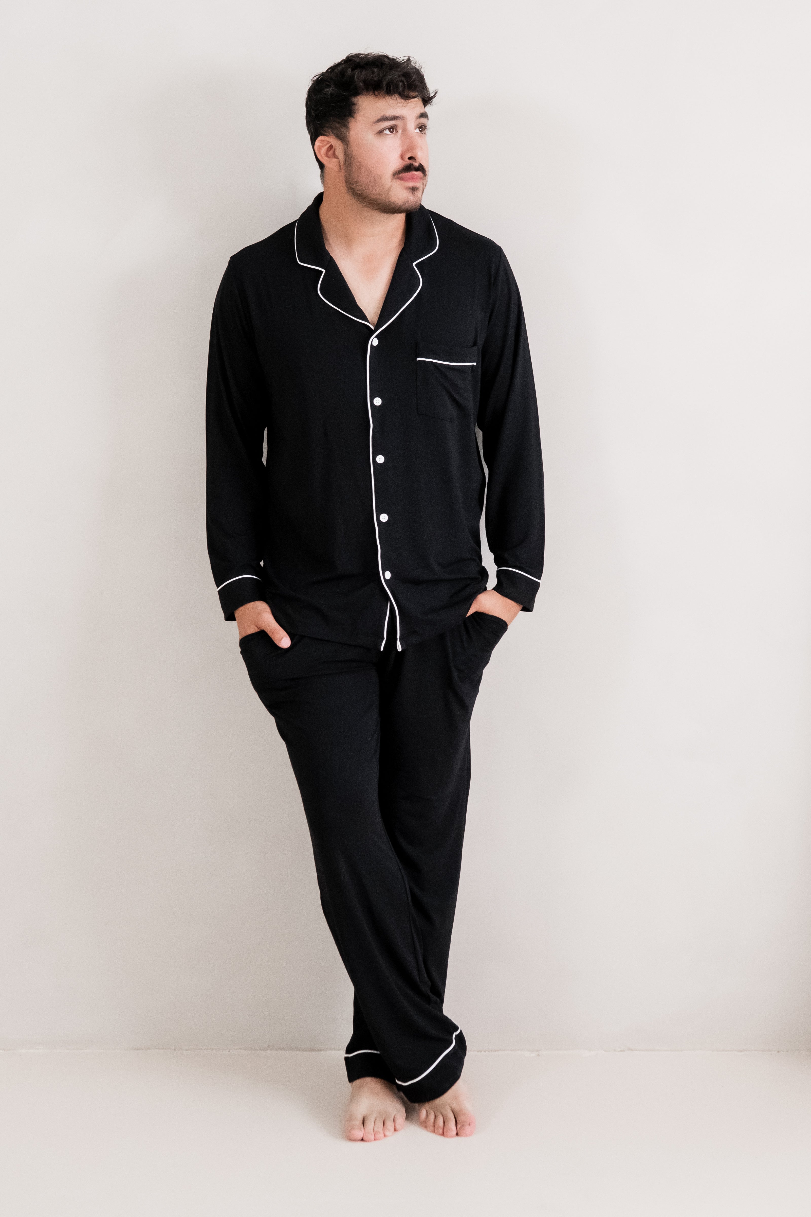 Male model posing wearing the Men's Long Sleeve Pajama Set in Midnight