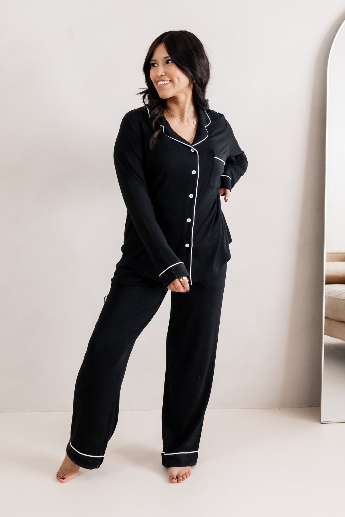 Female modeling the Long-Sleeved Women's Pajama Set in Midnight with Cloud Trim