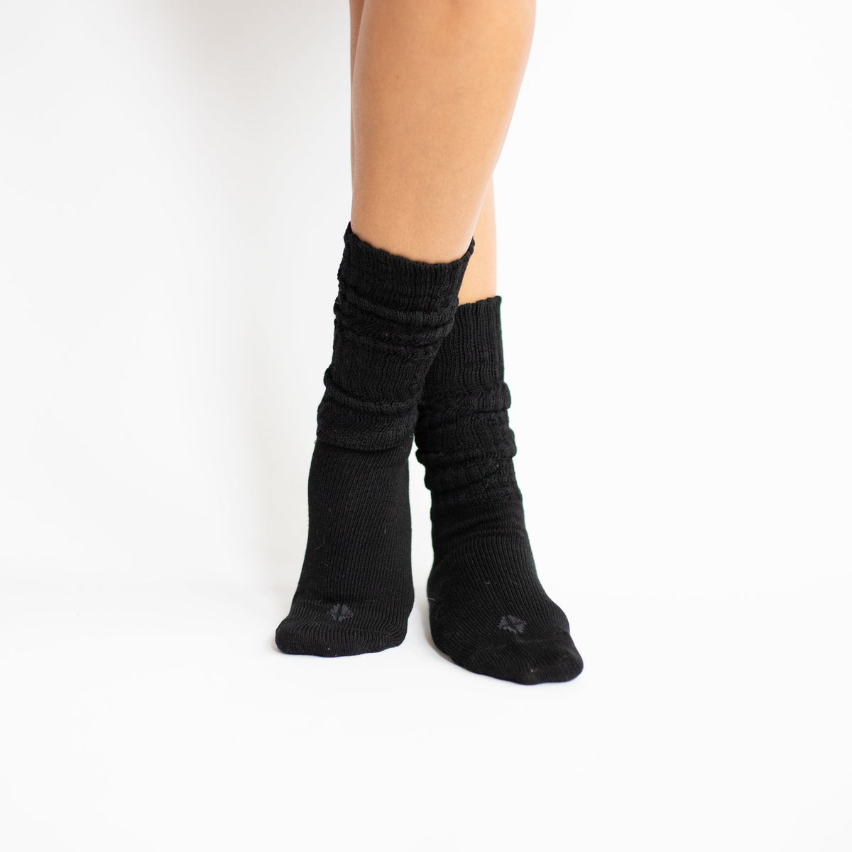 Models legs crossed together at the ankles wearing the Adult Crew Socks in Midnight