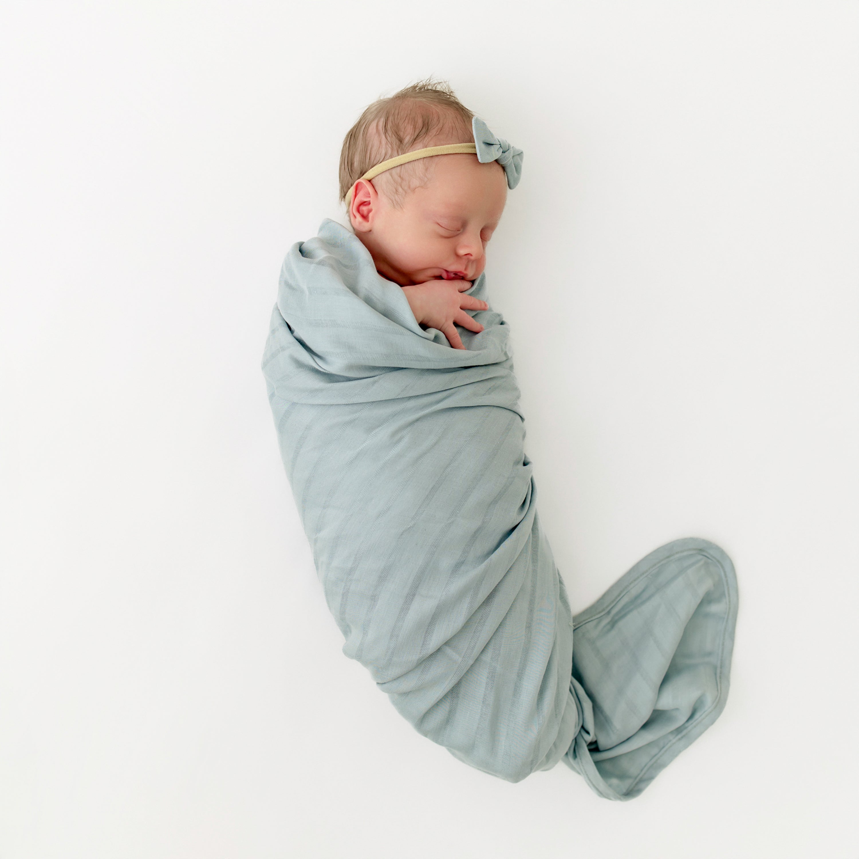 Newborn wrapped in Bamboo Muslin Swaddle Blanket in Mist