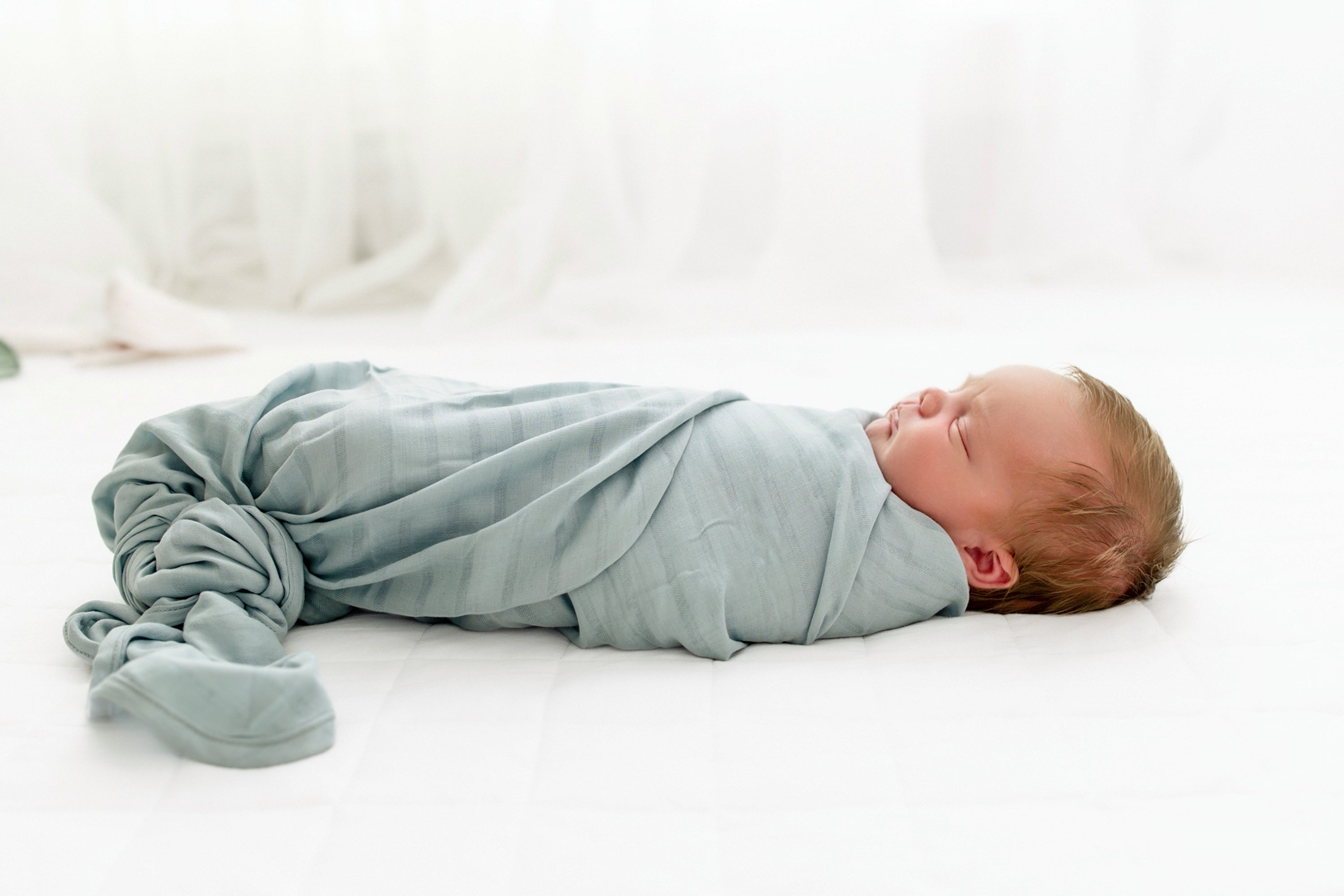 Newborn Wrapped in Blue Bamboo Muslin Swaddle Blanket in Mist