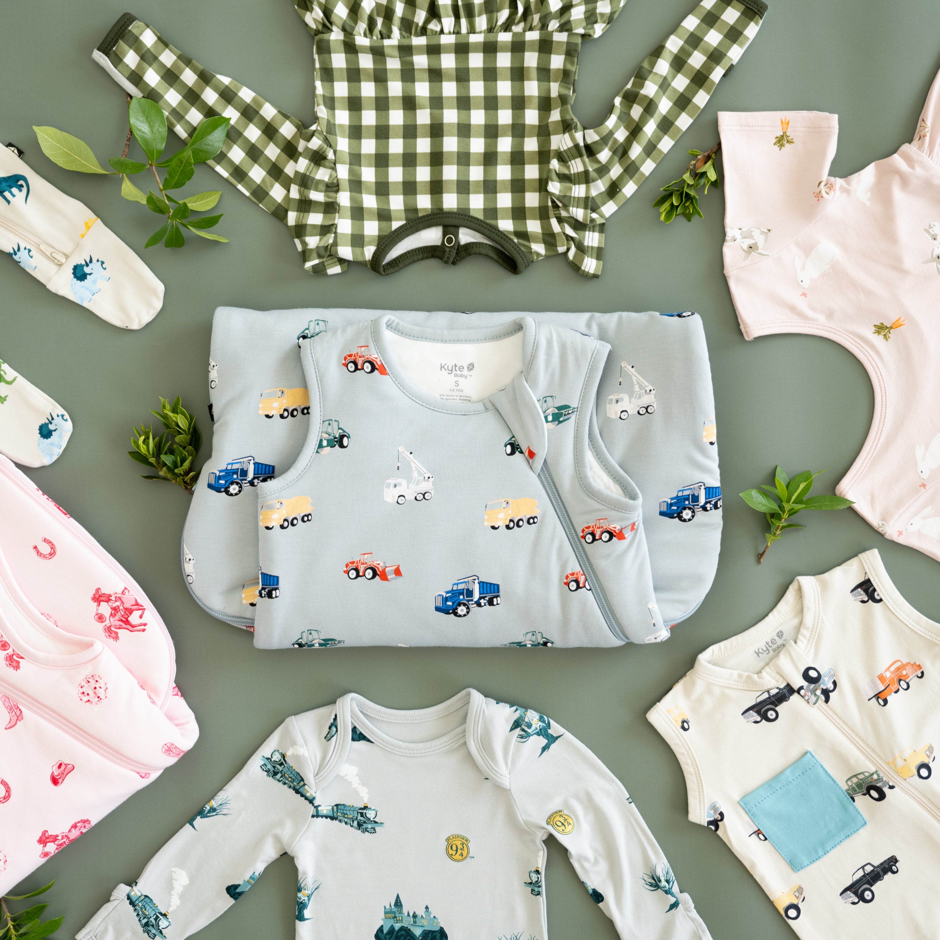 flat lay of kyte baby baby apparel and sleep bags in colorful prints