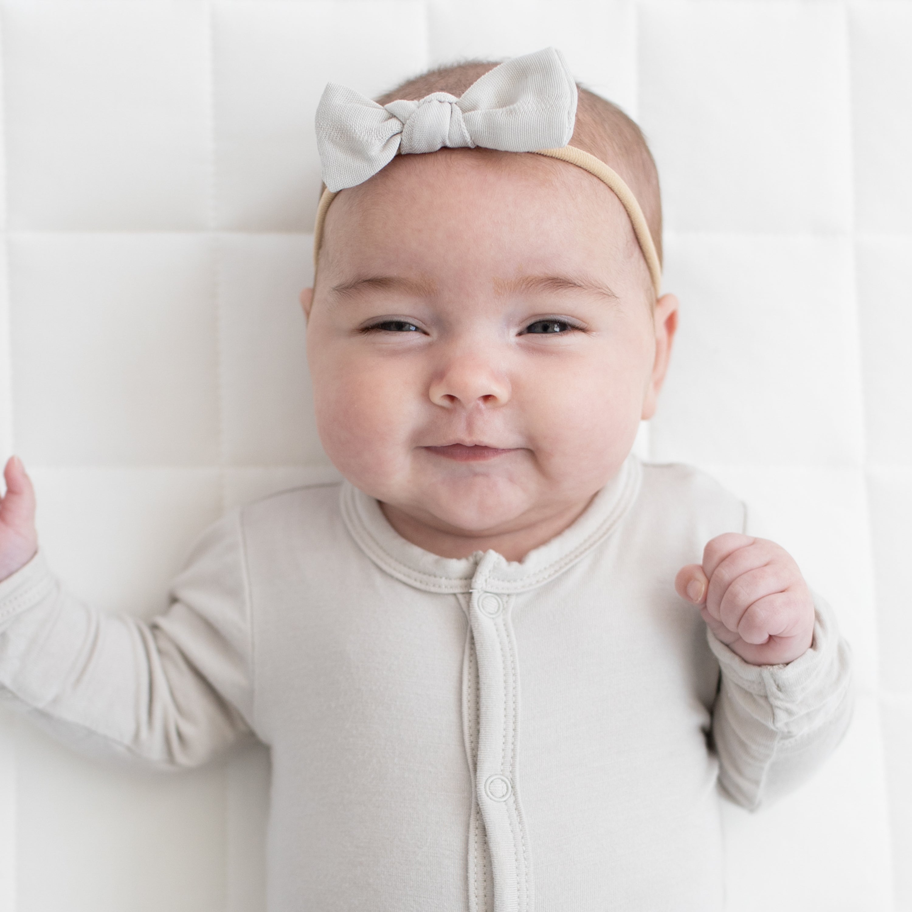 Infant wearing a Muslin Tiny Bow in Oat
