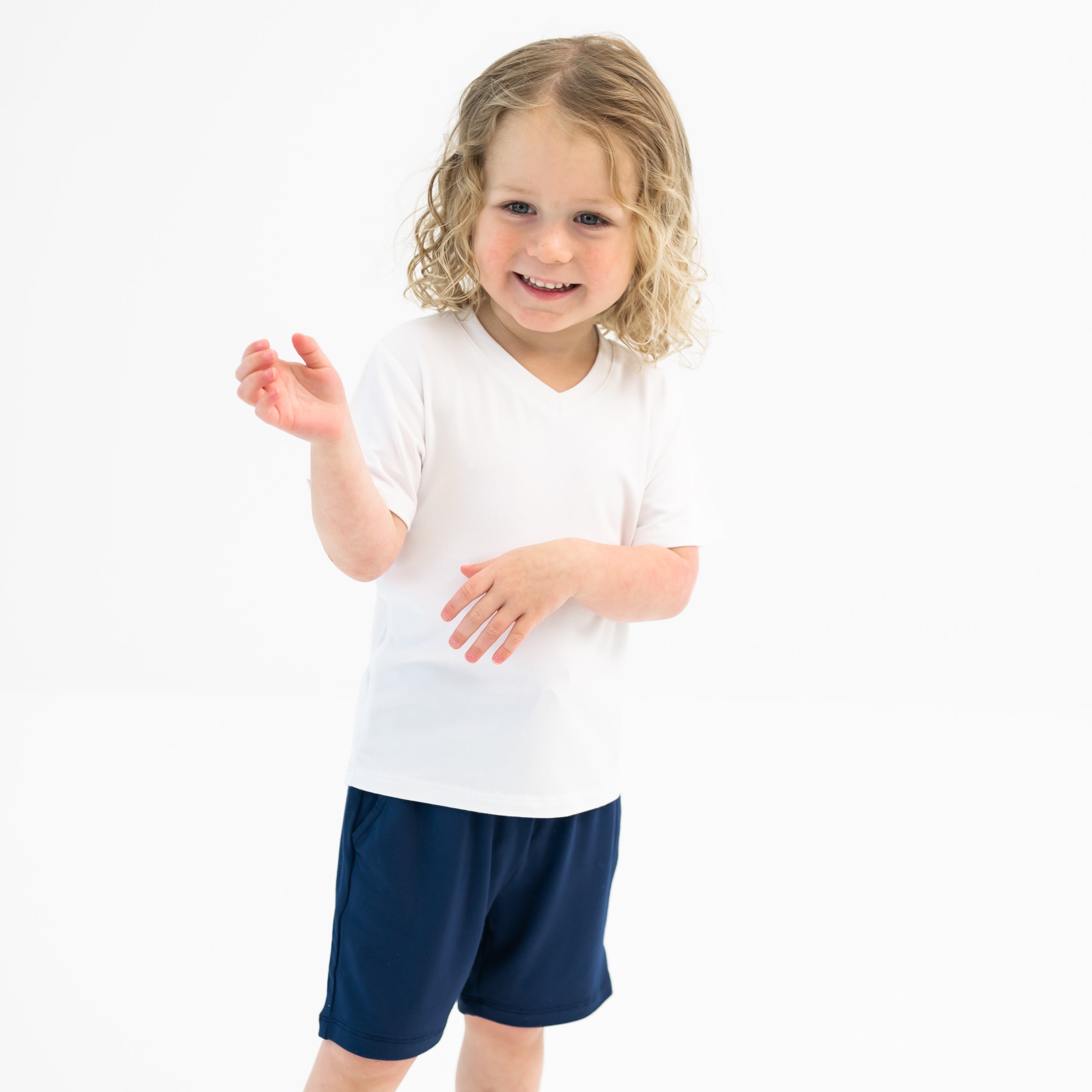 Toddler modeling Drawstring Short in Navy and Snow V-neck