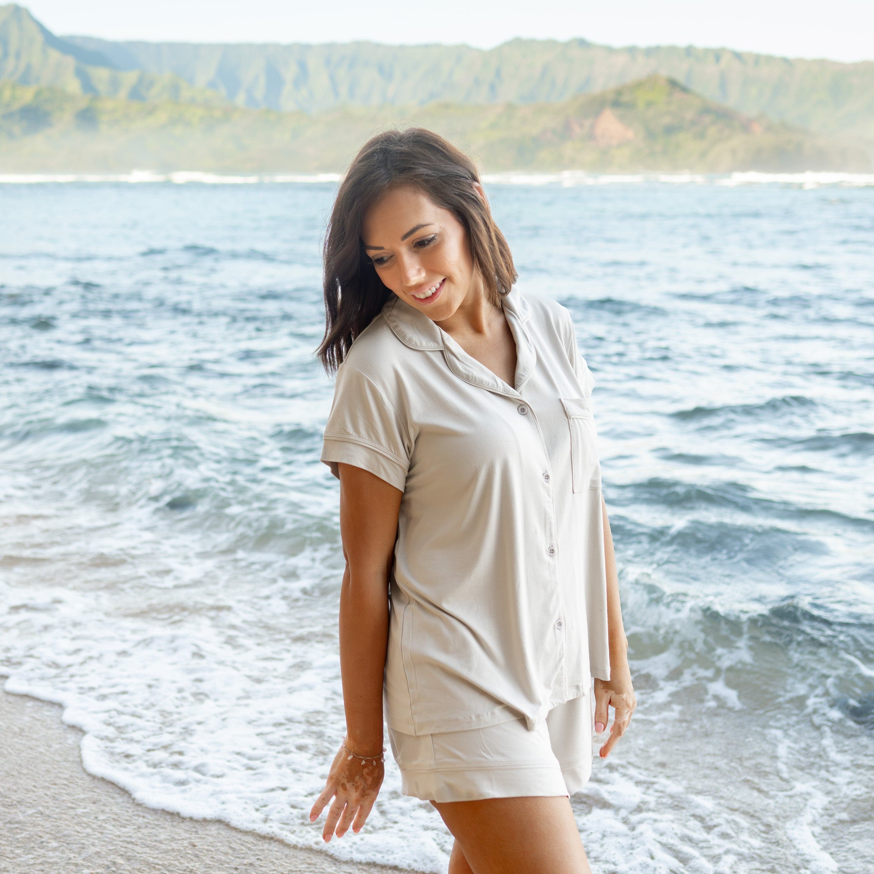 Woman modeling Women’s Short Sleeve Pajama Set in Oat on beach
