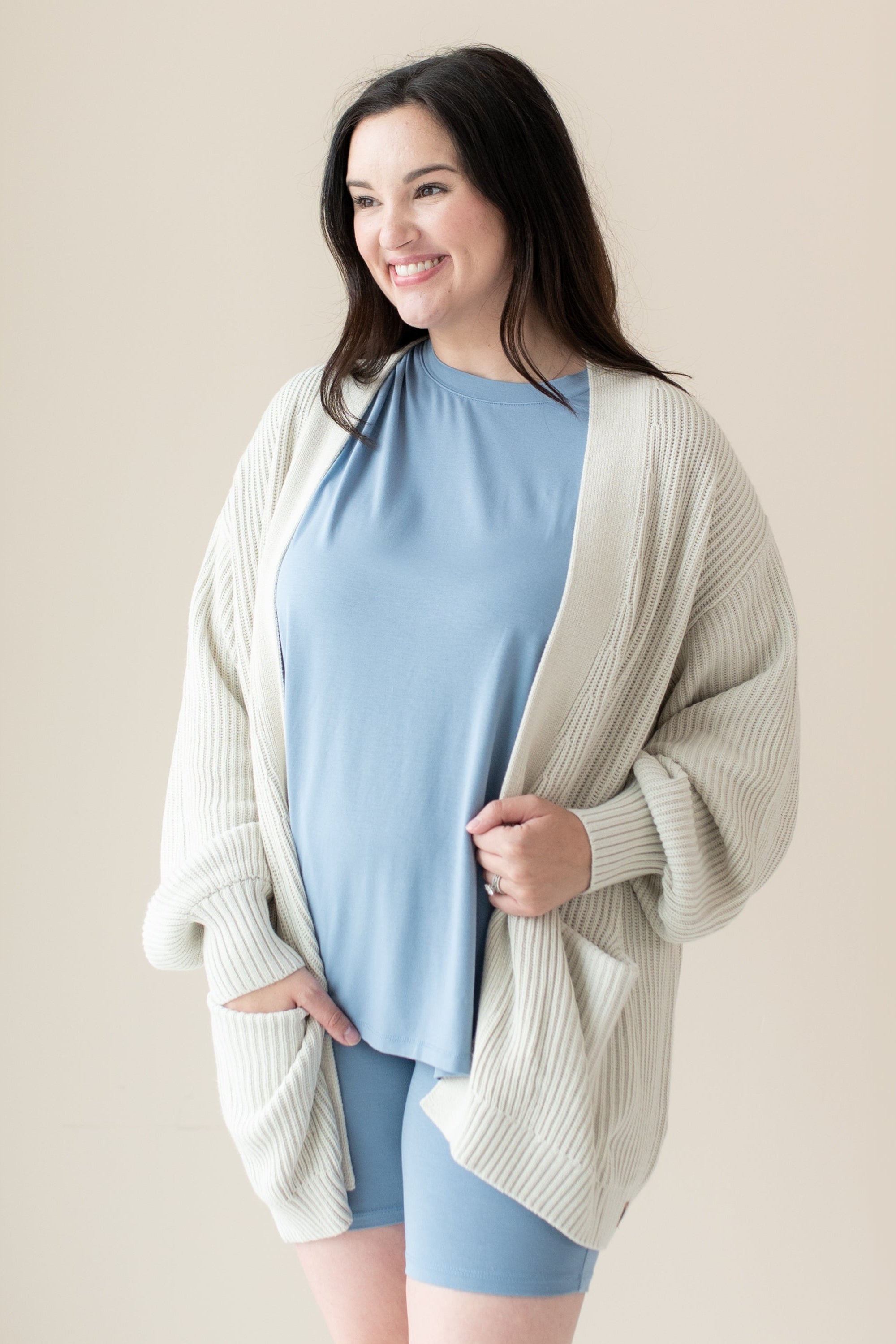 Woman modeling Chunky Knit Women's Oversized Cardigan in Oat and Slate Biker Short set