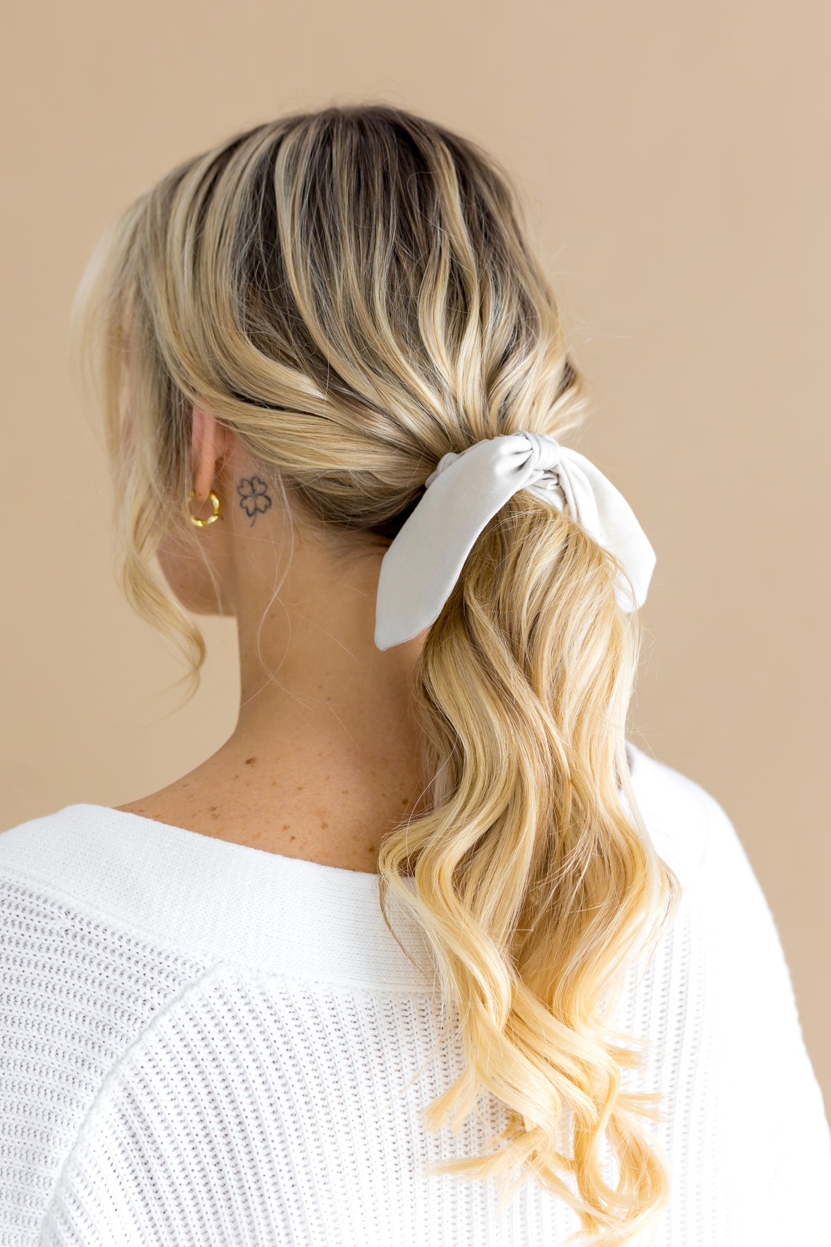 Scrunchie in Oat shown in a female models hair