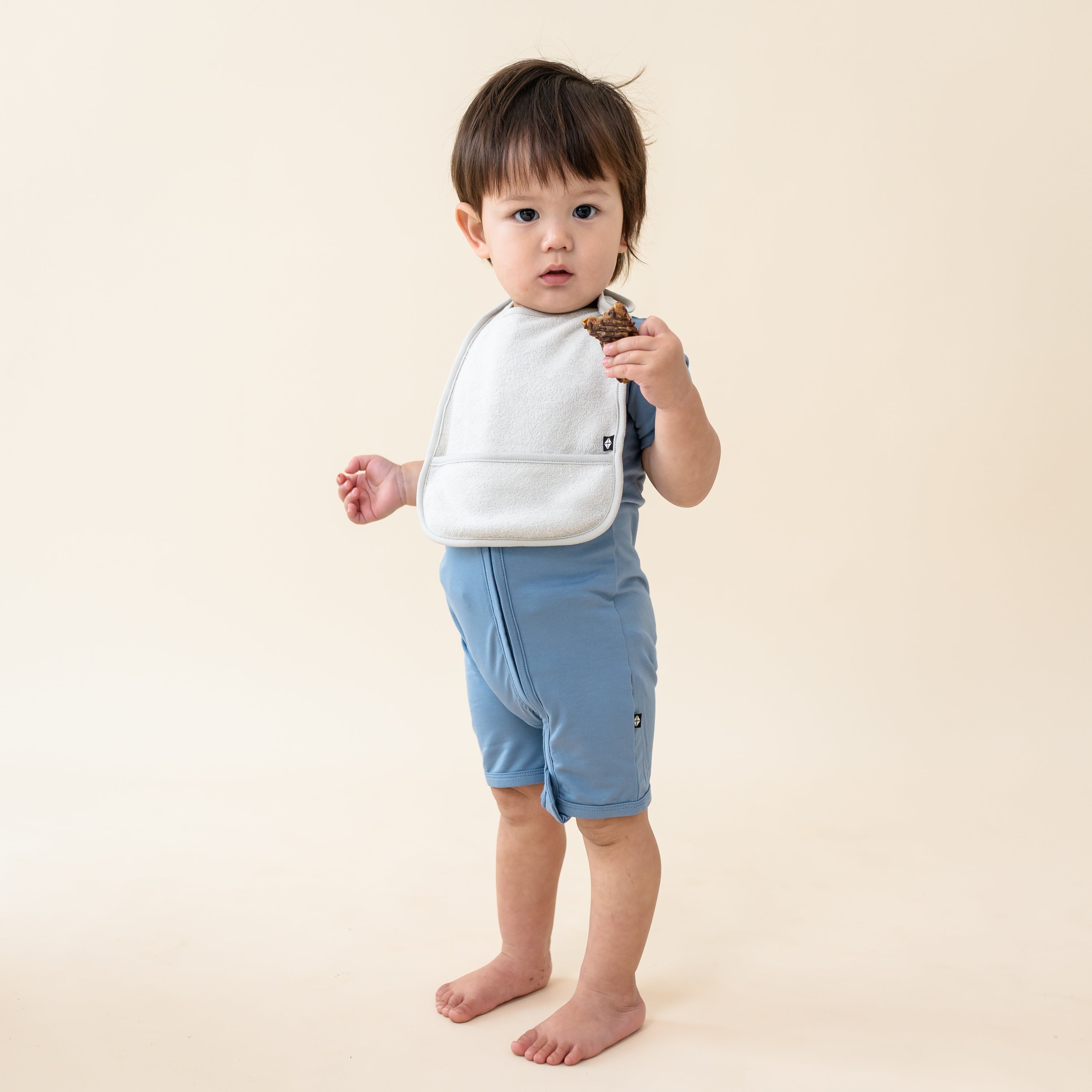 Toddler wearing Terry Pocket Bib in Oat