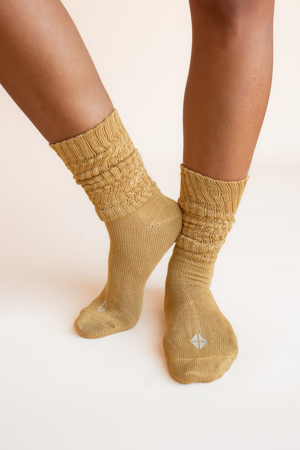 Modal wearing Adult Scrunch Socks in Ochre color on a beige background