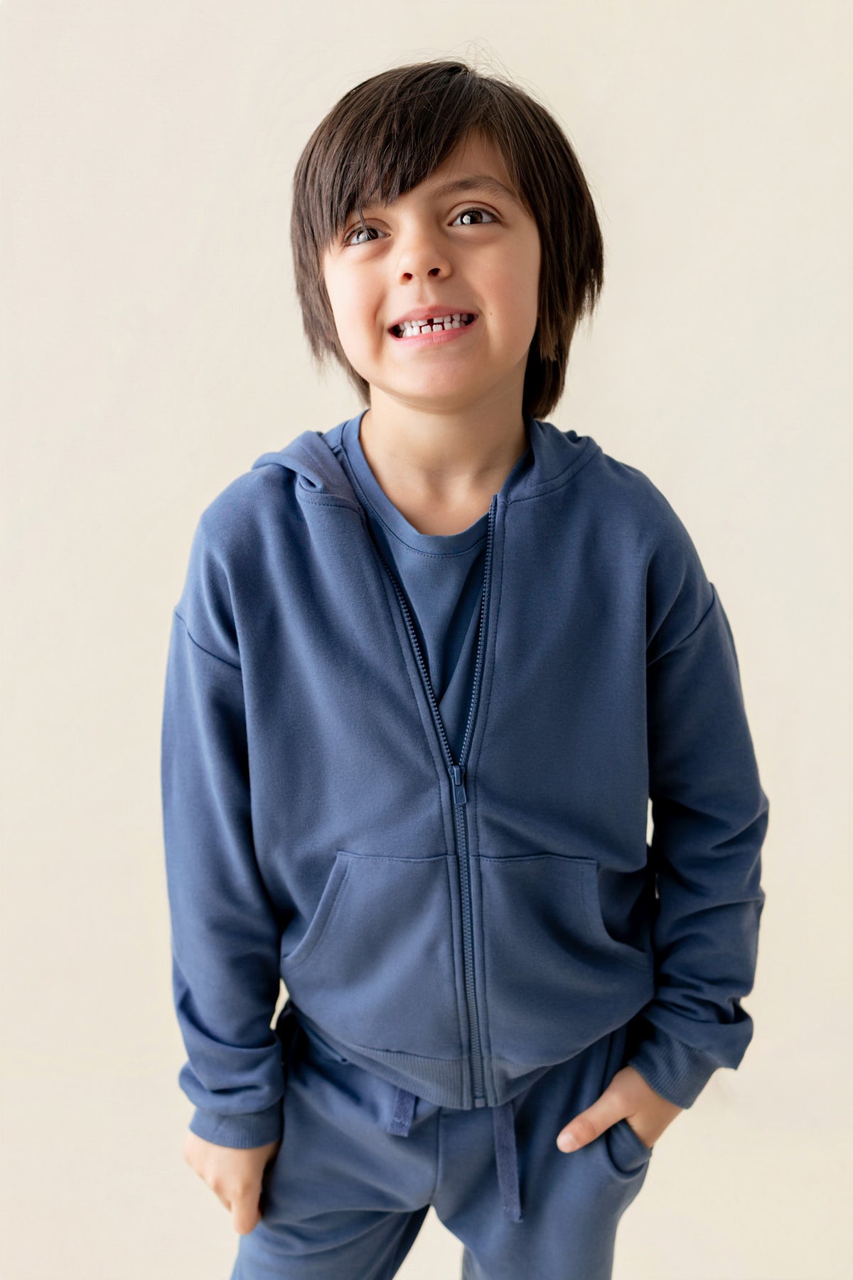 Boy wearing Hoodie in Oxford color on a beige background